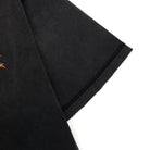 Black fabric with a small orange logo on a white background