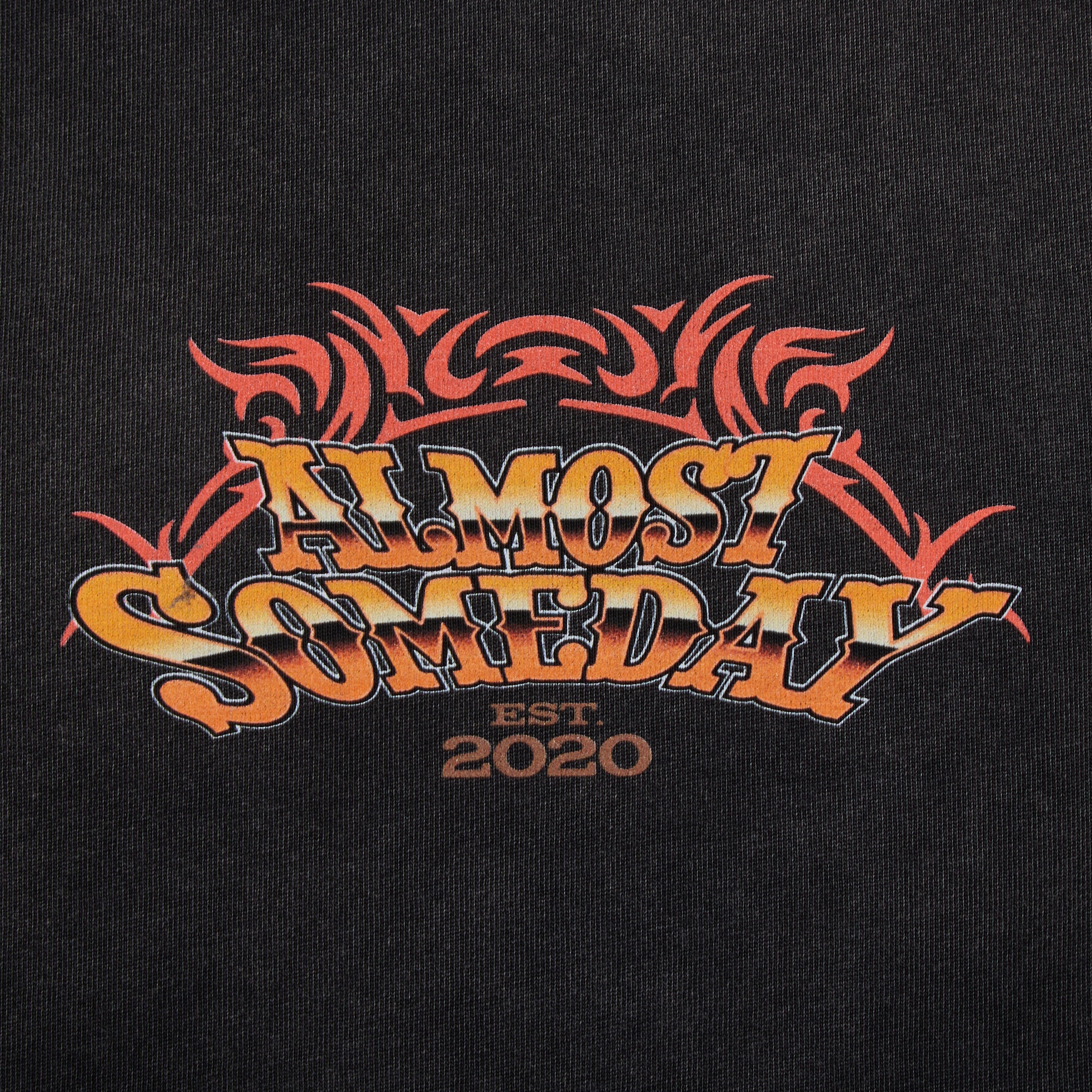 Black t-shirt with 'Almost Someday' logo and 'Est. 2020' text on a dark background