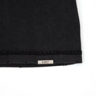 Black fabric with a 'ALMOST' label on a white background