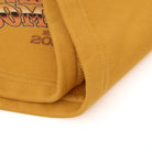 Close-up of a mustard yellow sweatshorts fabric with text on a white background