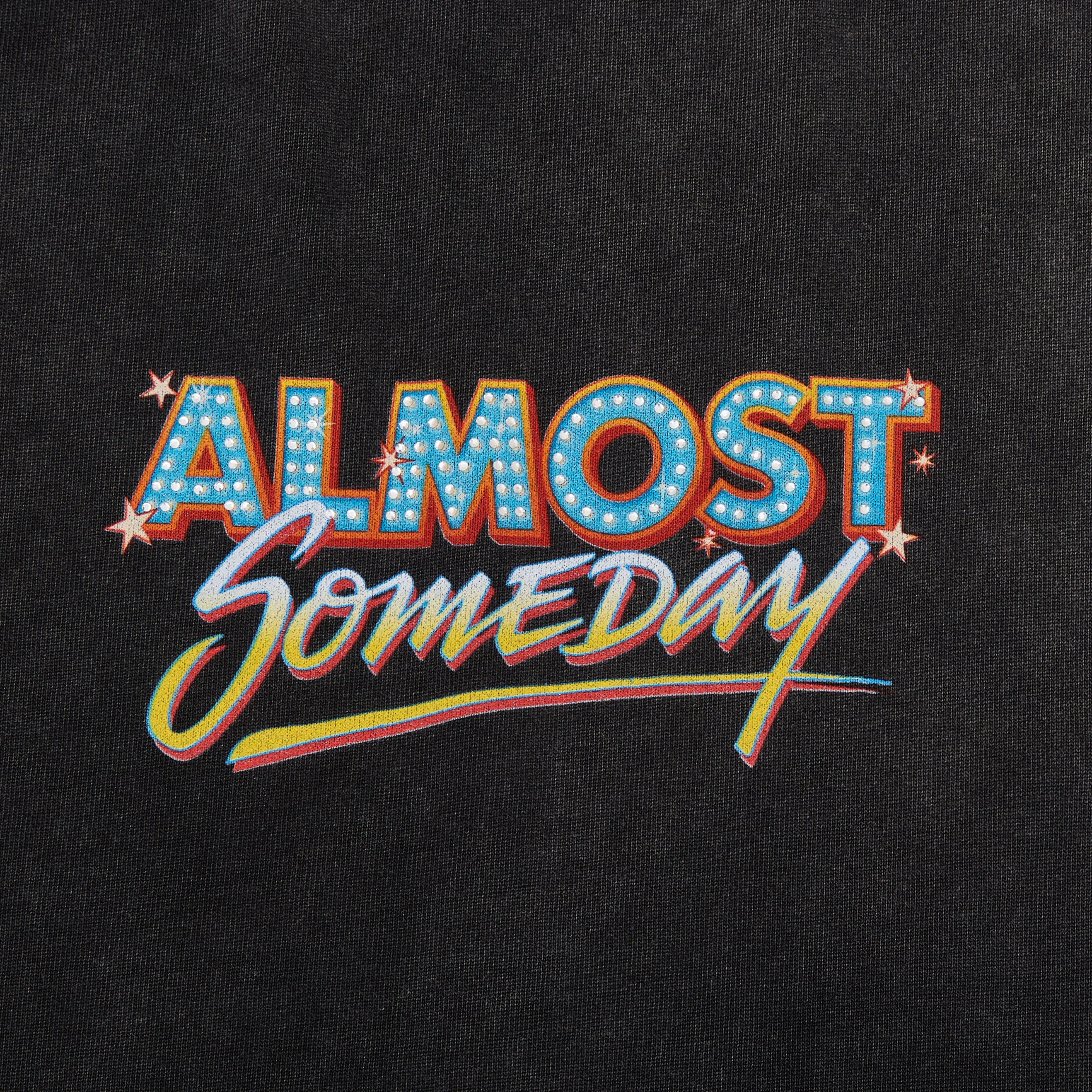Text 'ALMOST Someday' on a black background with colorful design elements.