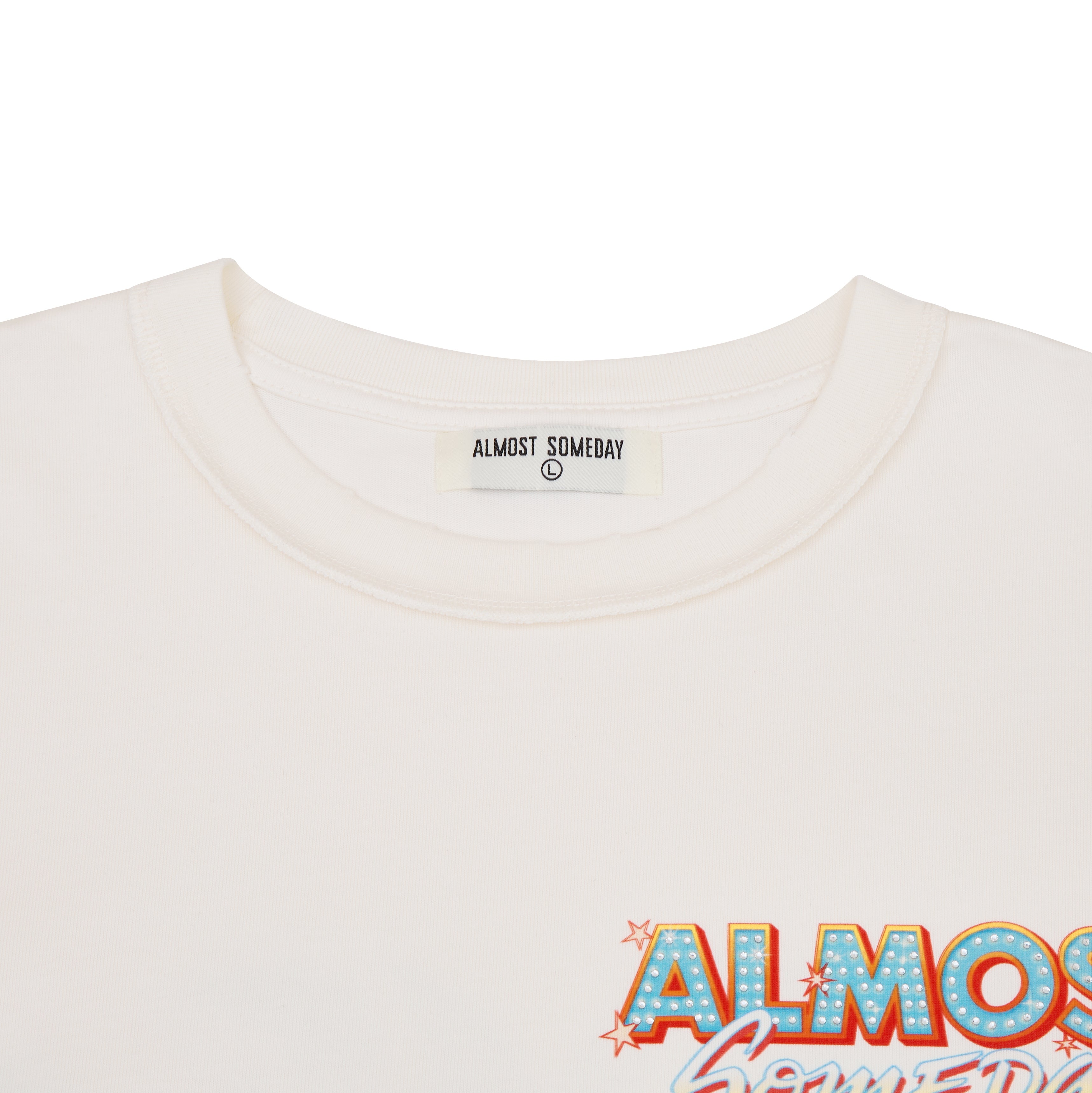 Close-up of a white t-shirt with 'Almost Someday' branding and design.