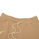 Close-up of beige sweatshorts with a drawstring on a white background