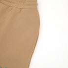 Close-up of beige pants on a white background