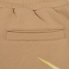 Close-up of a beige fabric pocket with a brand logo.