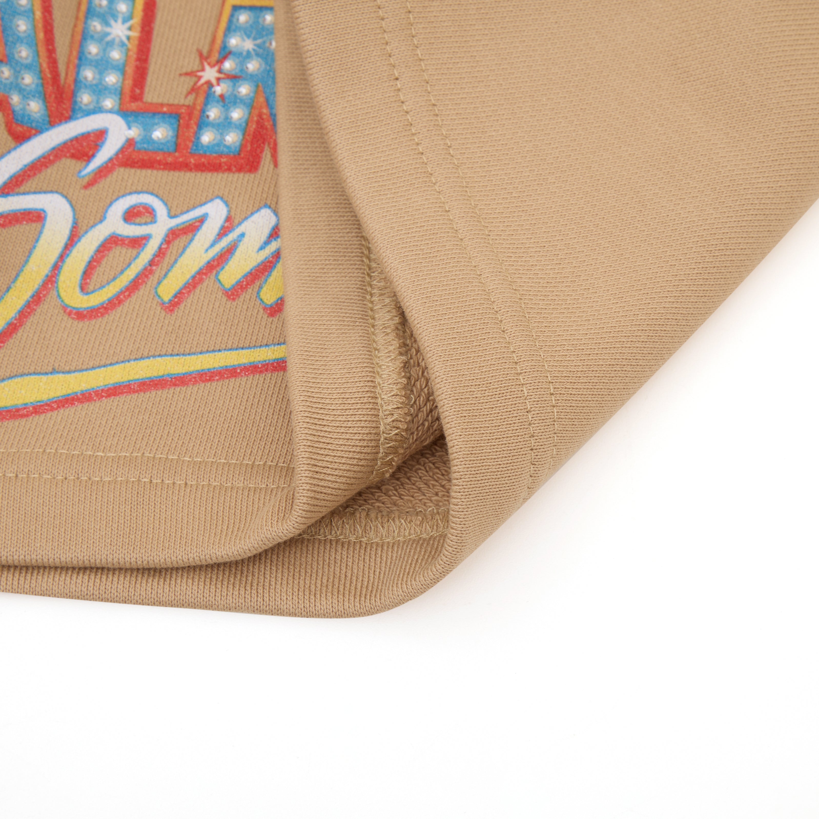 Close-up of a beige fabric with colorful text design on a white background