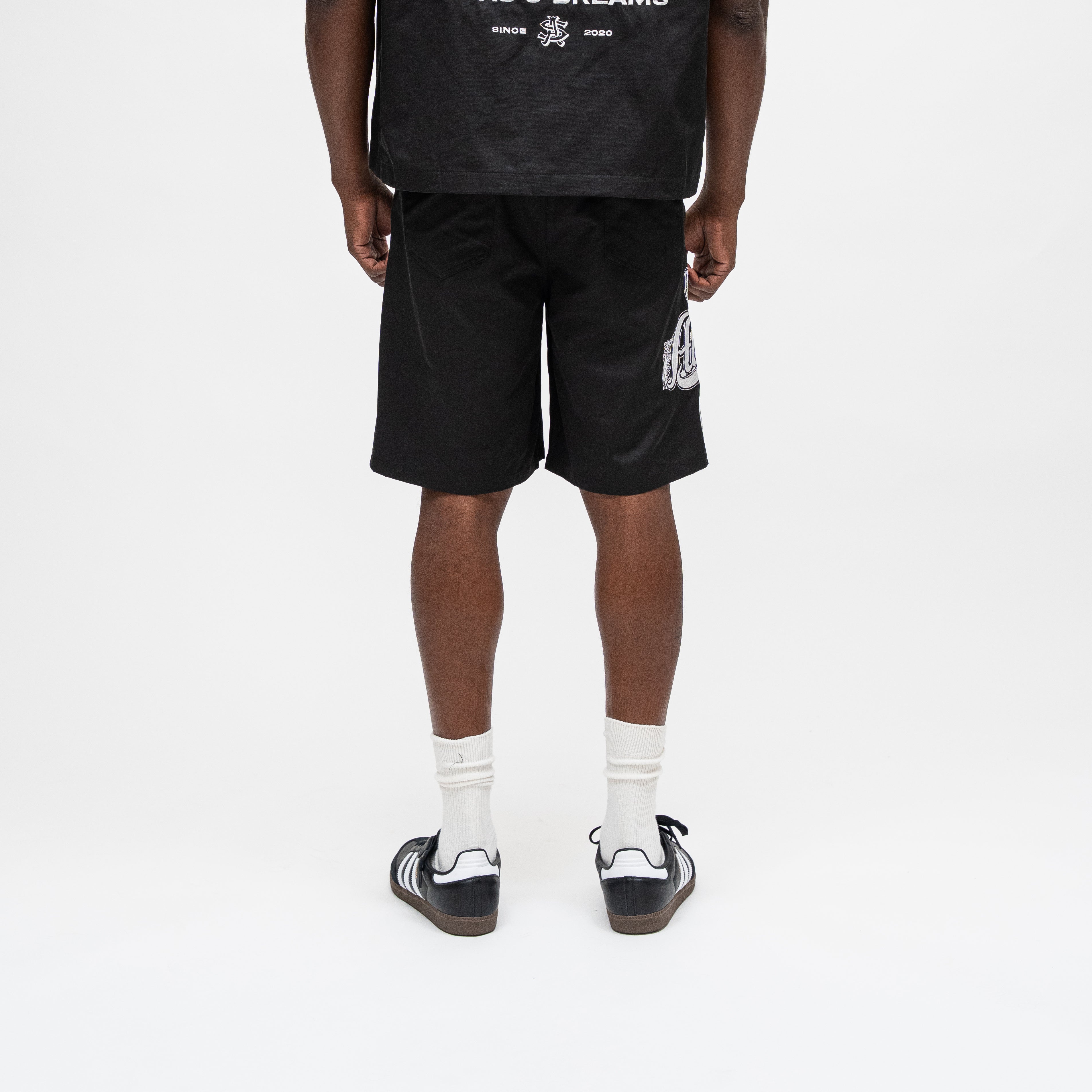 ALMOST SOMEDAY Vision Nylon Short in Black, back view showing relaxed fit and graphic detailing