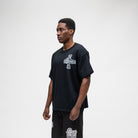 ALMOST SOMEDAY Vision Tee in Black, lifestyle shot angled front view showing boxy oversized fit 