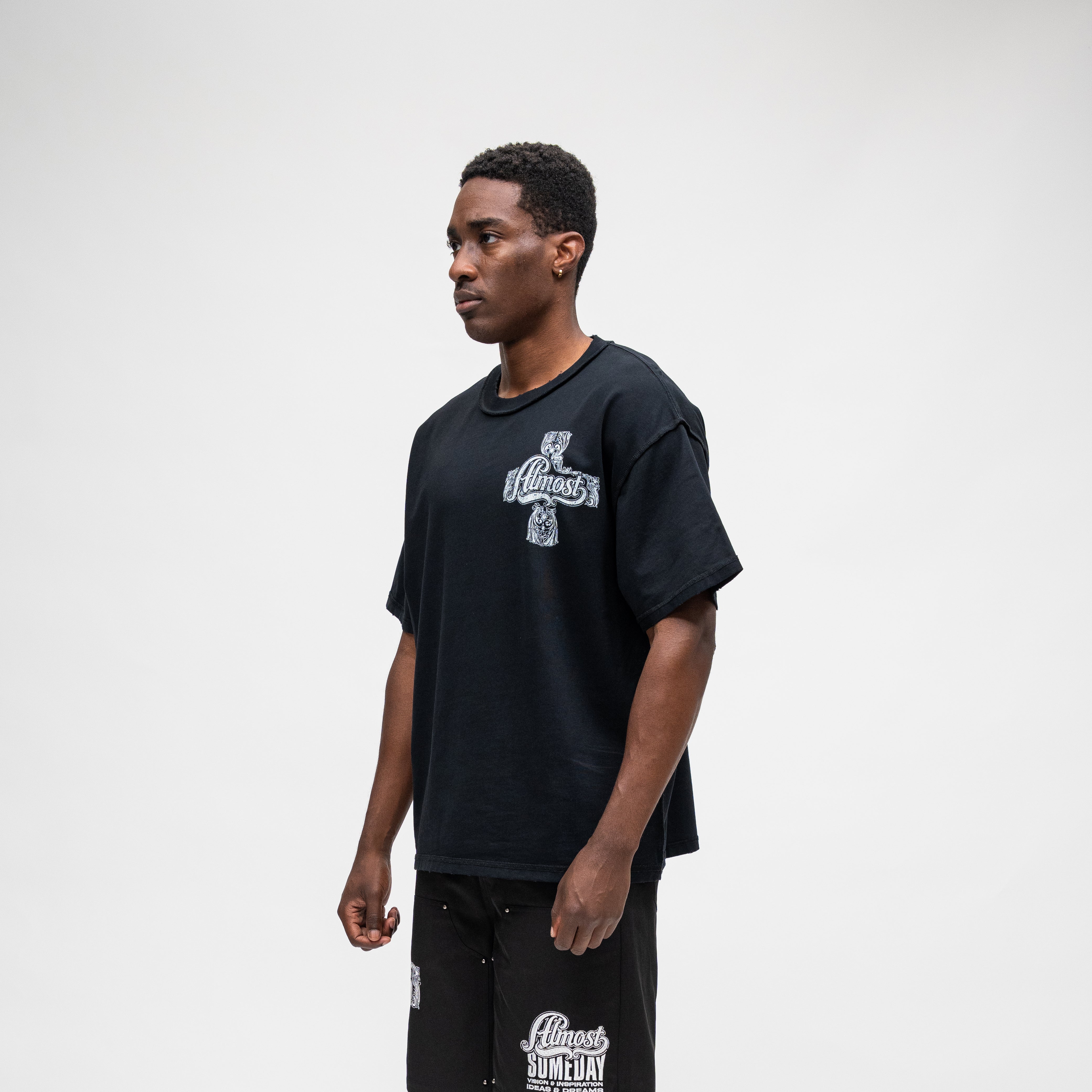 ALMOST SOMEDAY Vision Tee in Black, lifestyle shot angled front view showing boxy oversized fit 