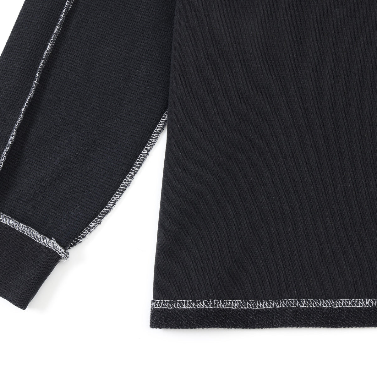 Alumni Crewneck – Black – Close-up of sleeve cuff and lower body with white contrast stitching