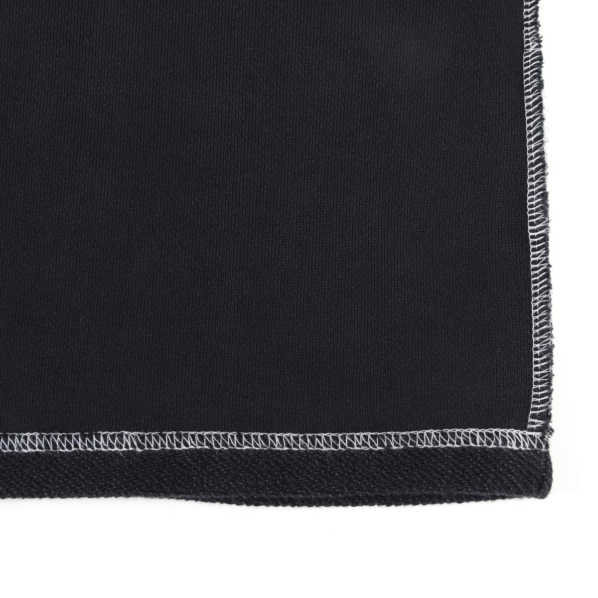 Alumni Crewneck – Black – Close-up of bottom hem corner and white contrast side seam stitching