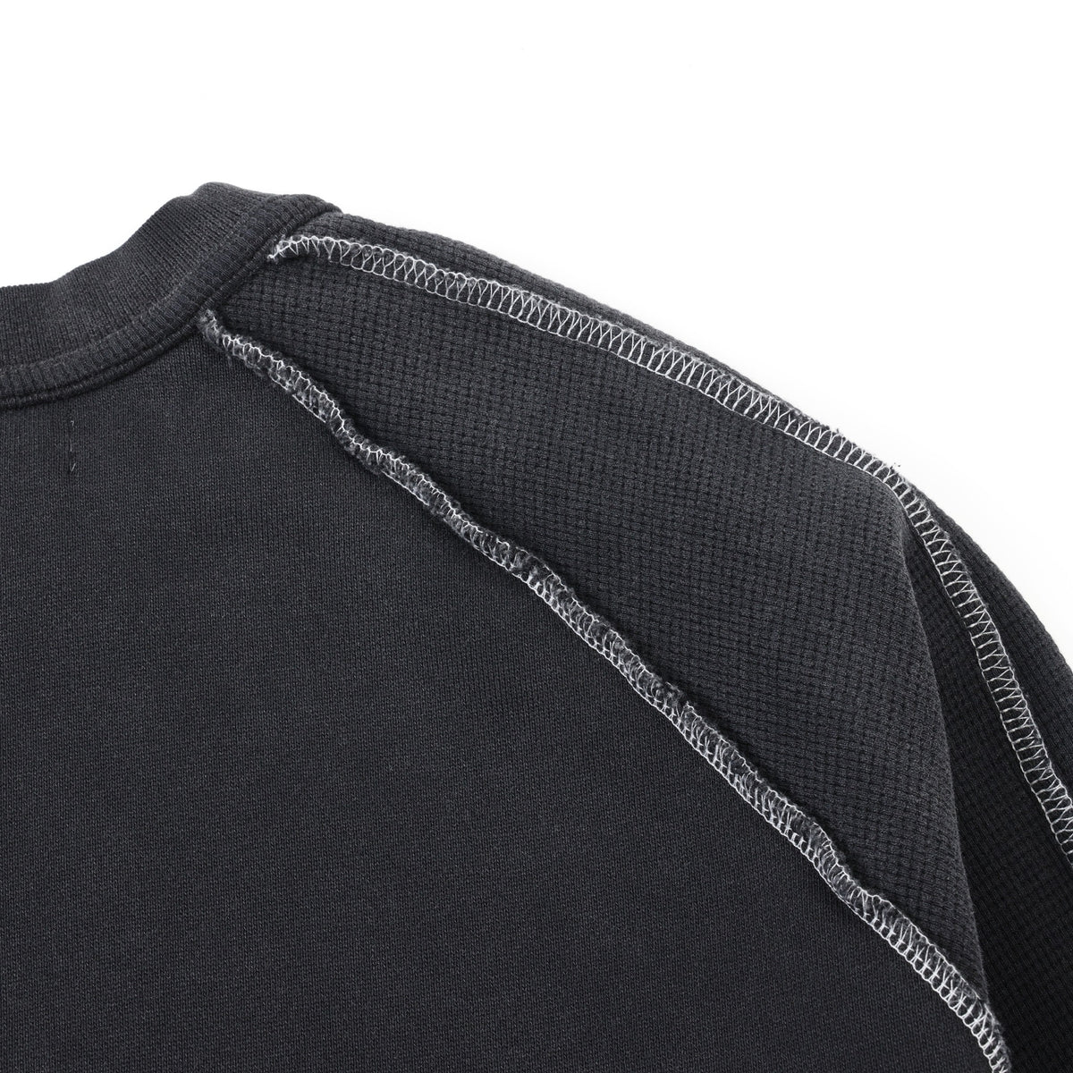 Alumni Crewneck – Black – Close-up of back shoulder panel with textured fabric and white contrast stitching