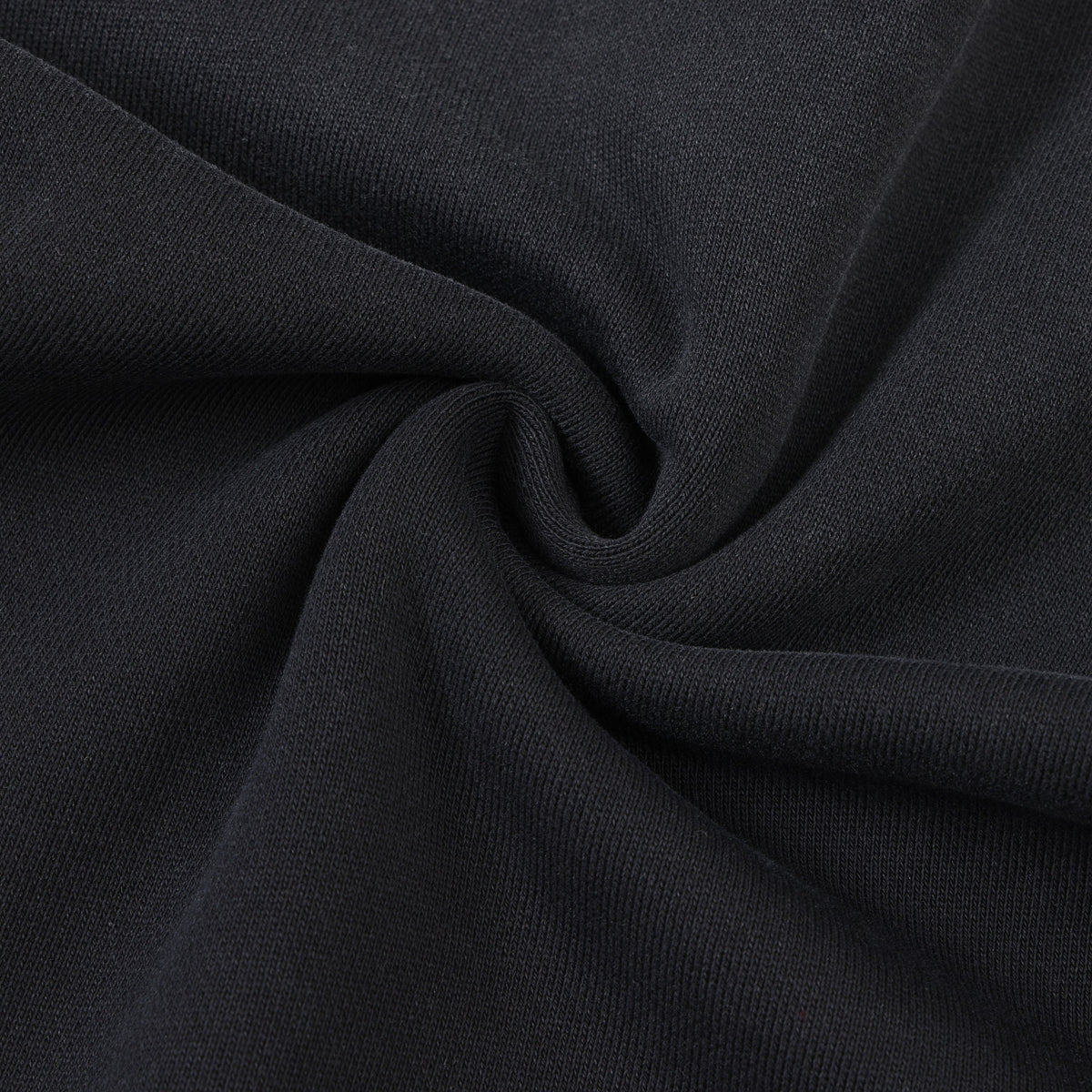 Alumni Crewneck – Black – Close-up of gathered black fabric showing knit texture