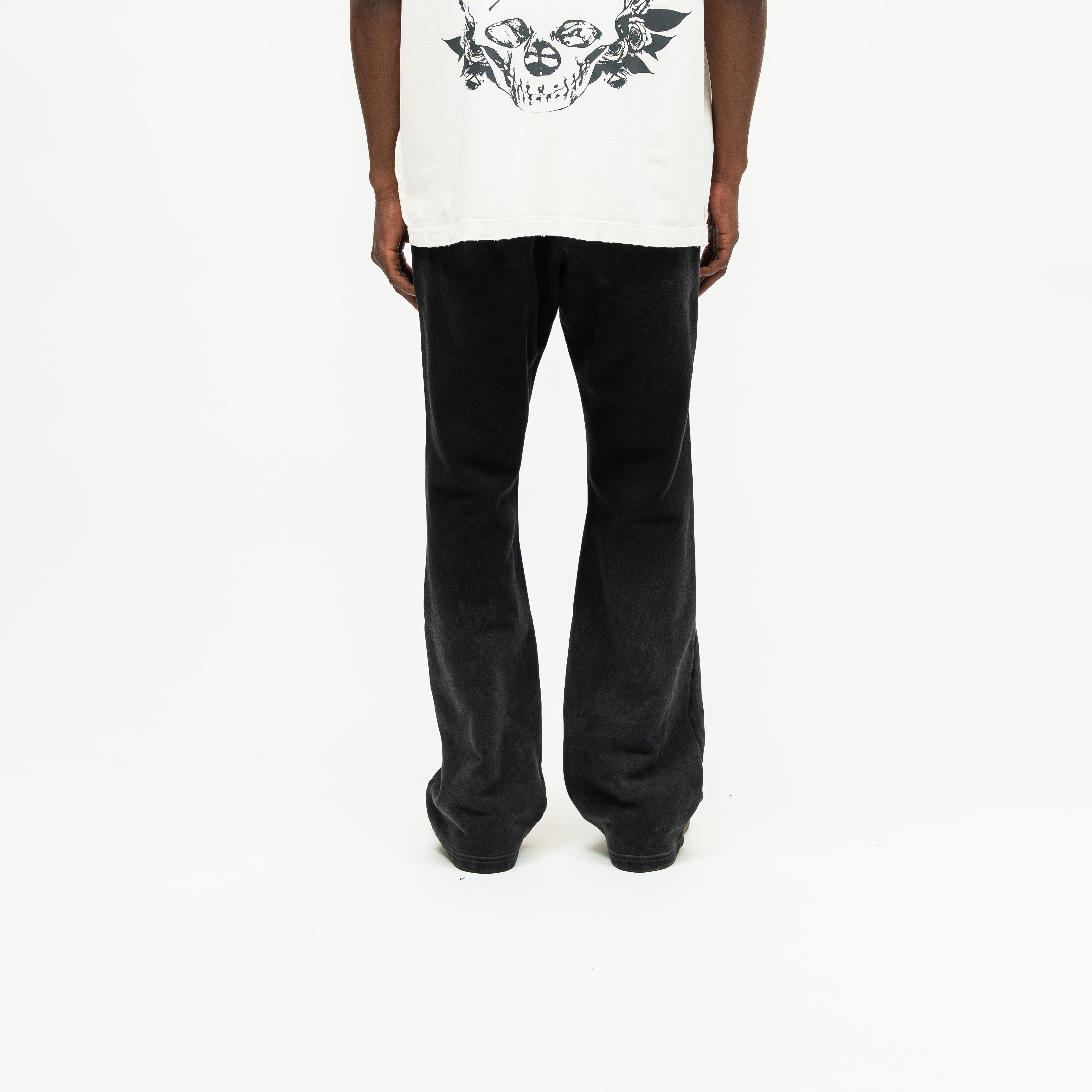 Enemies Flare Bottoms – Black – Back view on model styled with a cream tee, showing plain back and flared legs