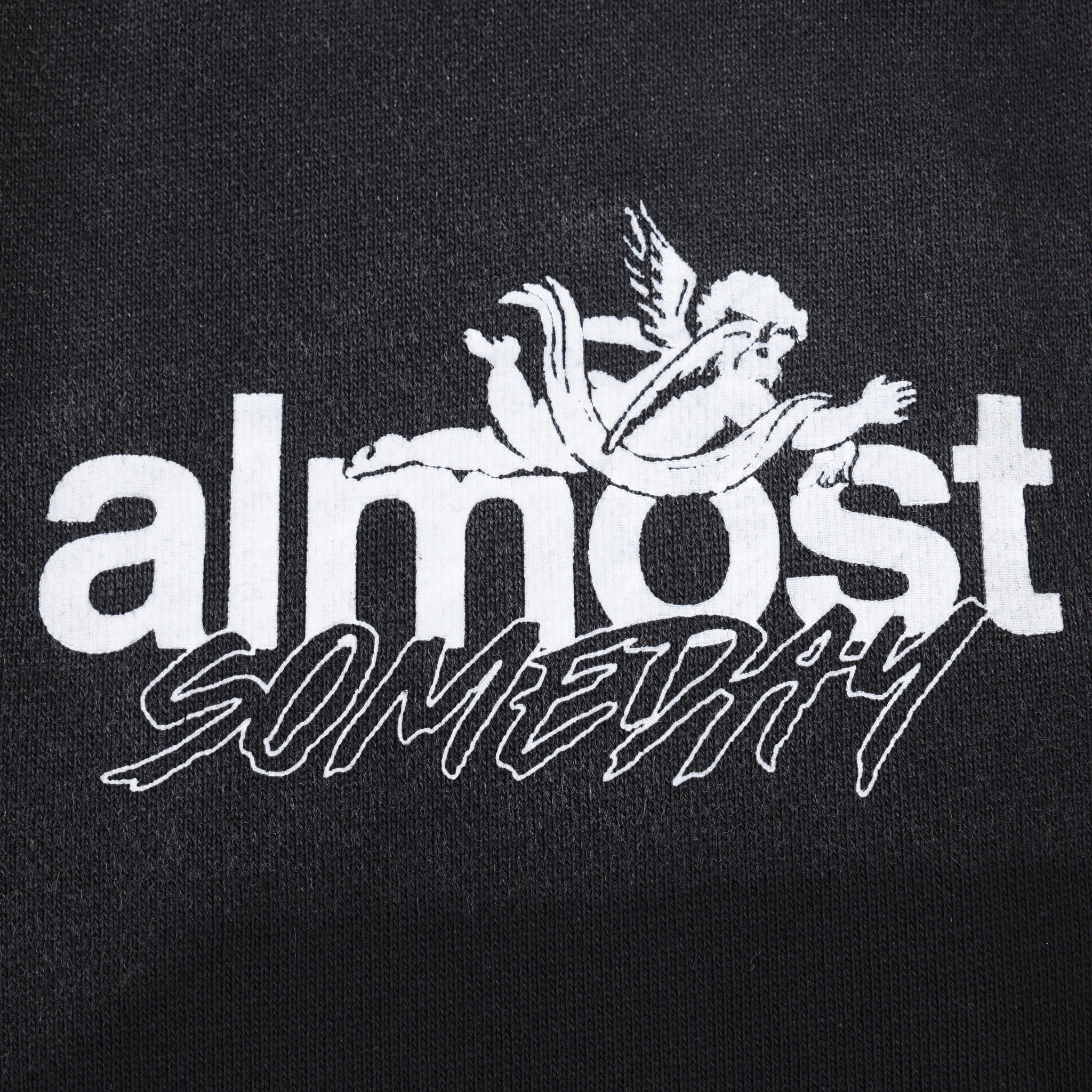 Enemies Flare Bottoms – Black – Close-up of white ALMOST SOMEDAY lettering and winged figure logo