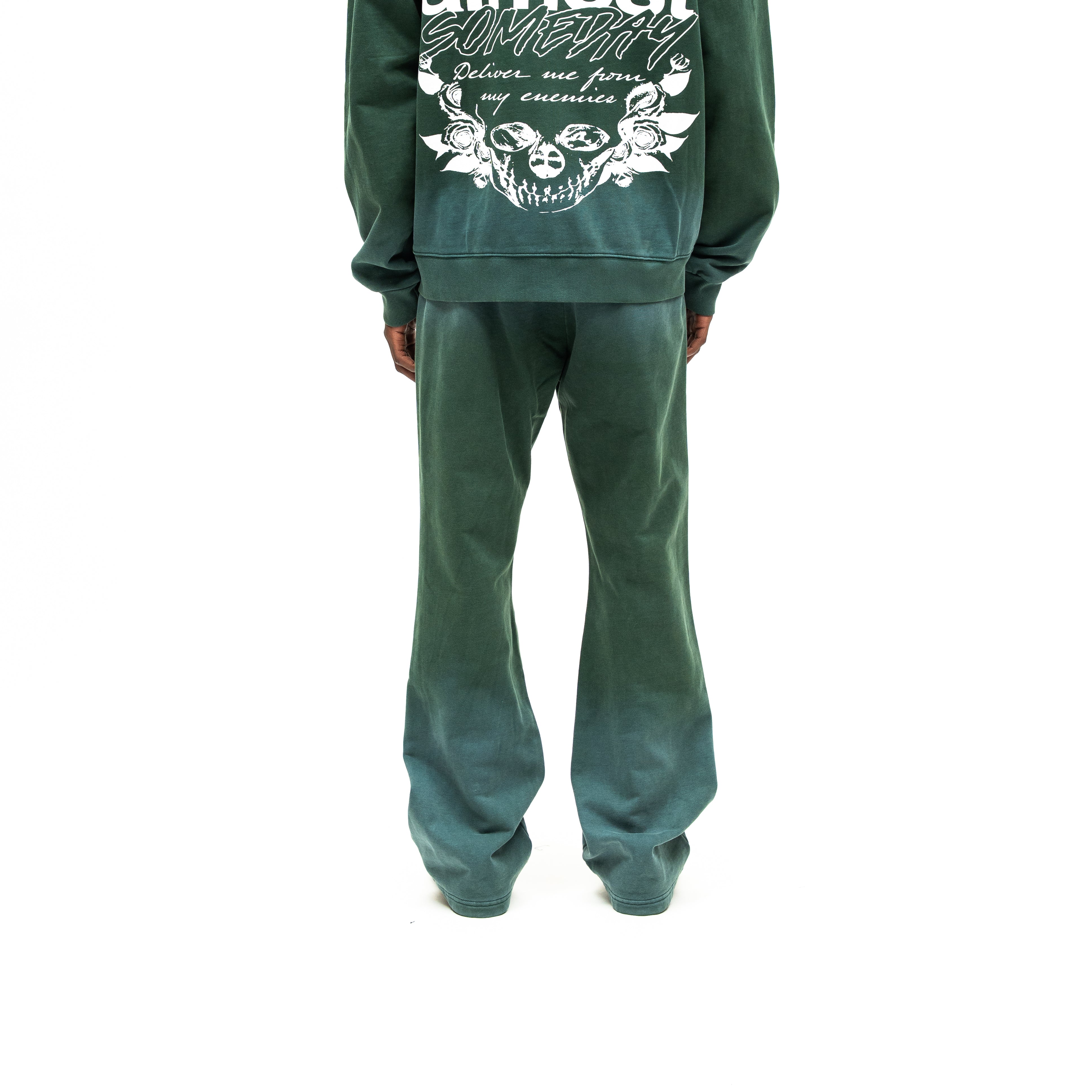 Enemies Flare Bottoms – Green – Back view on model styled with a matching zip hoodie, showing flared legs and faded green finish