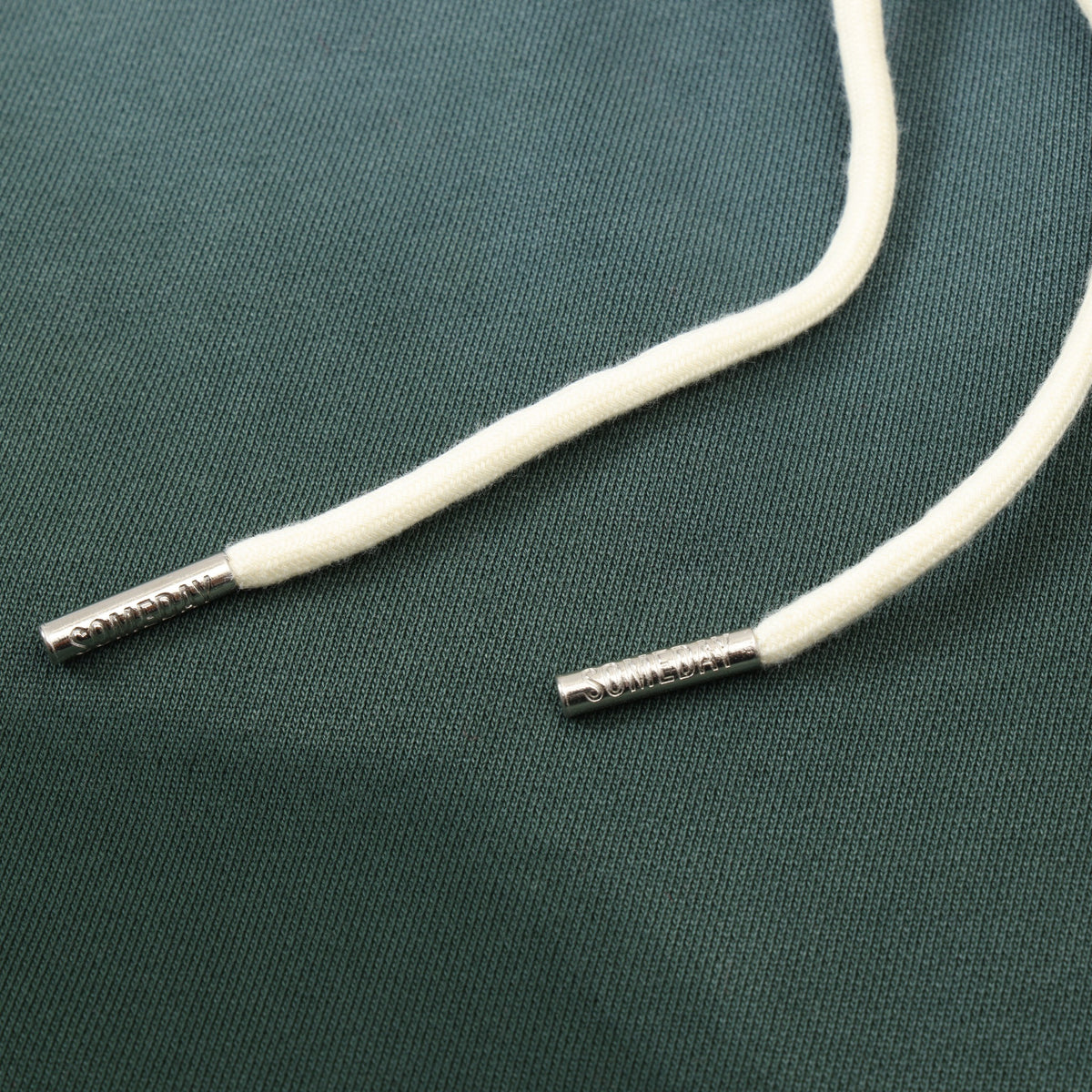 Enemies Flare Bottoms – Green – Close-up of white drawstrings with silver-tone branded metal tips