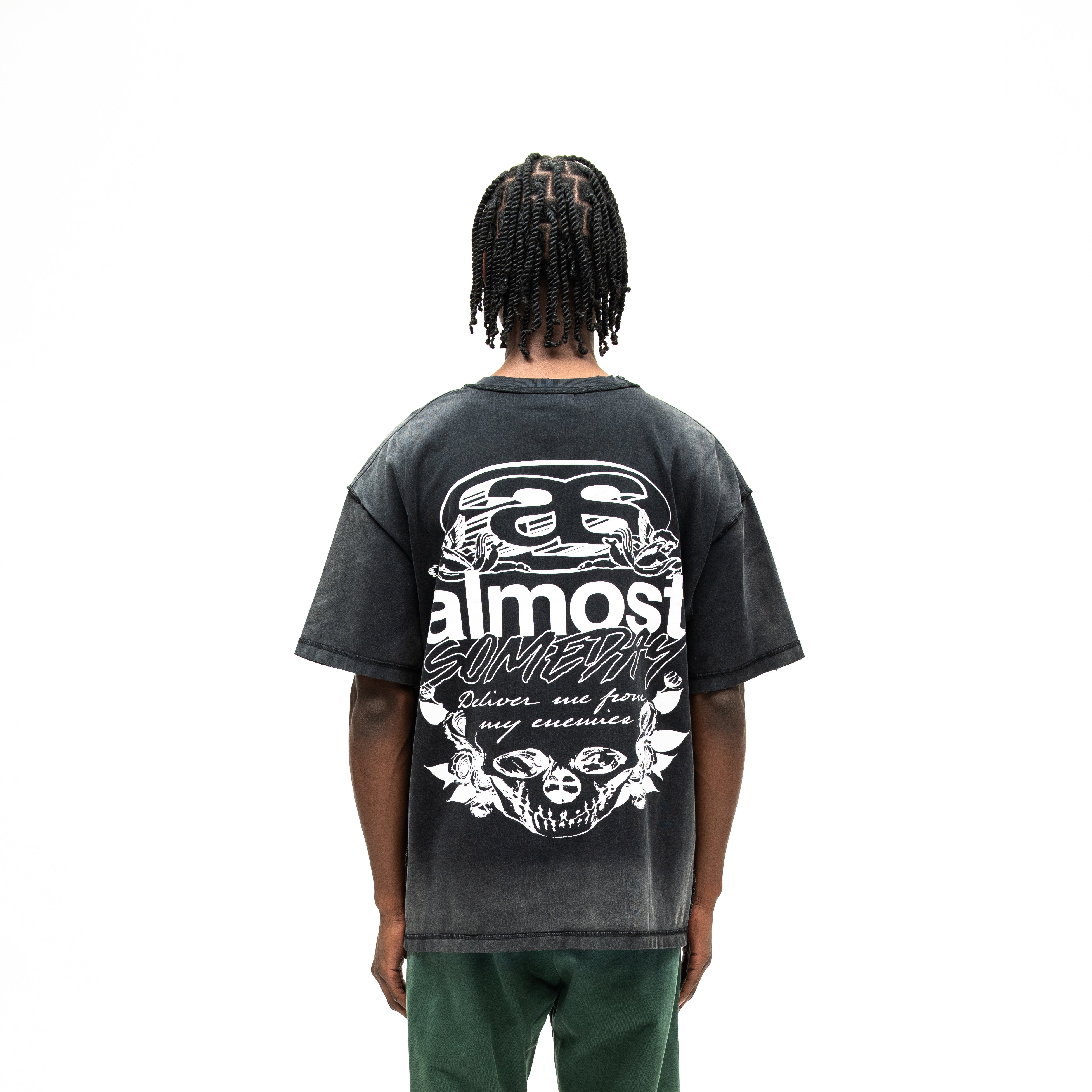Enemies Tee – Black – Back view on model showing large white lettering, cherubs, roses, and skull graphic