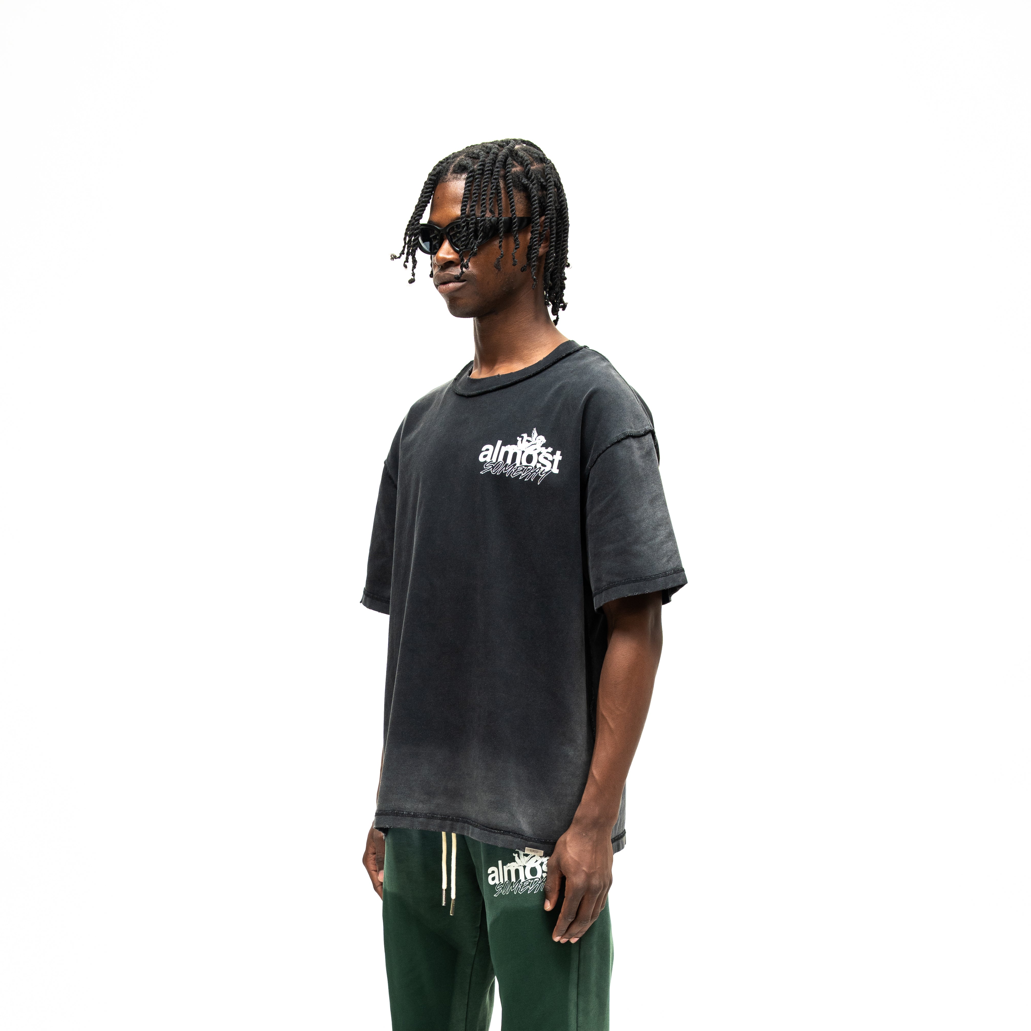 Enemies Tee – Black – Three-quarter front view on model showing chest logo and dropped shoulders