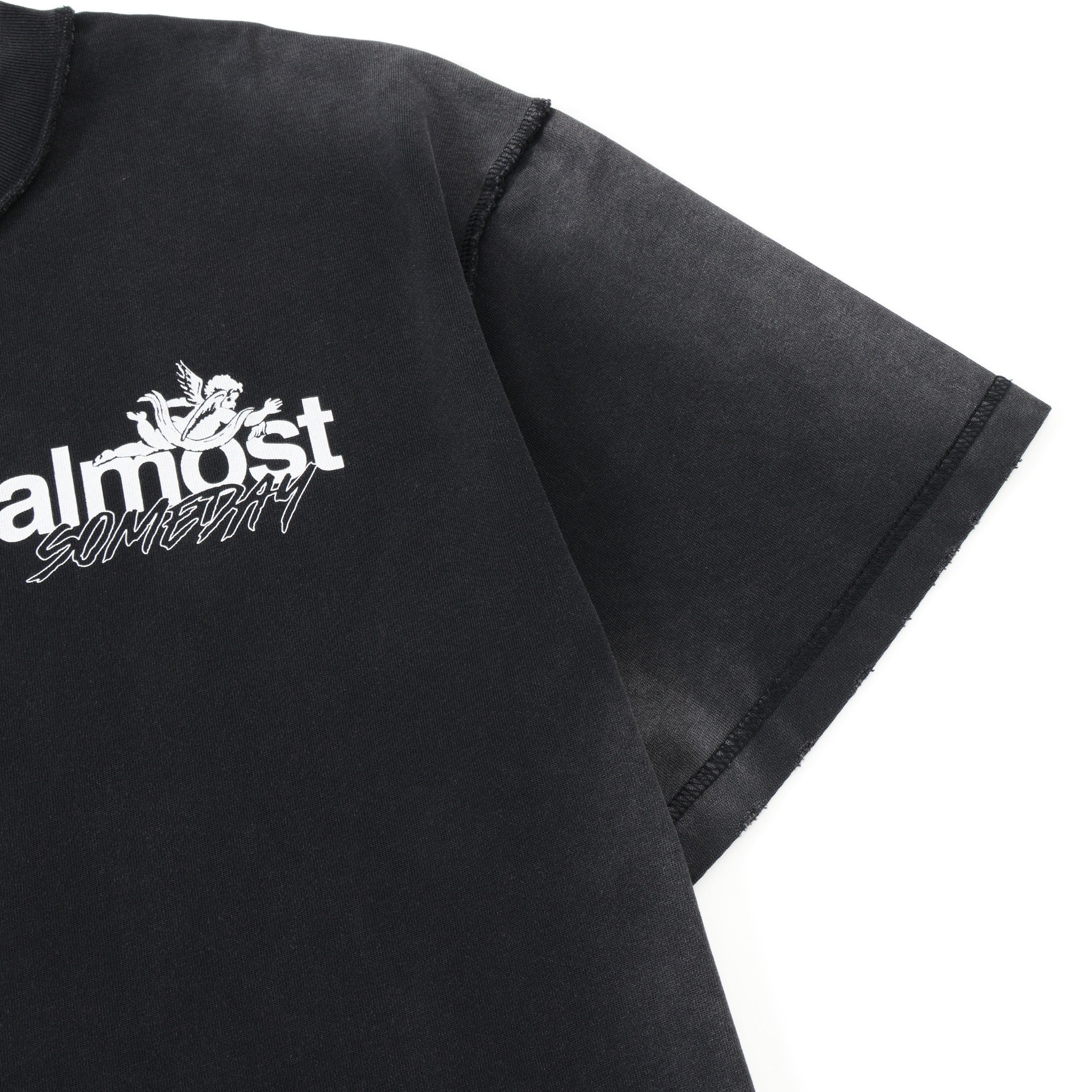 Enemies Tee – Black – Close-up of chest logo, shoulder seam, and sleeve stitching