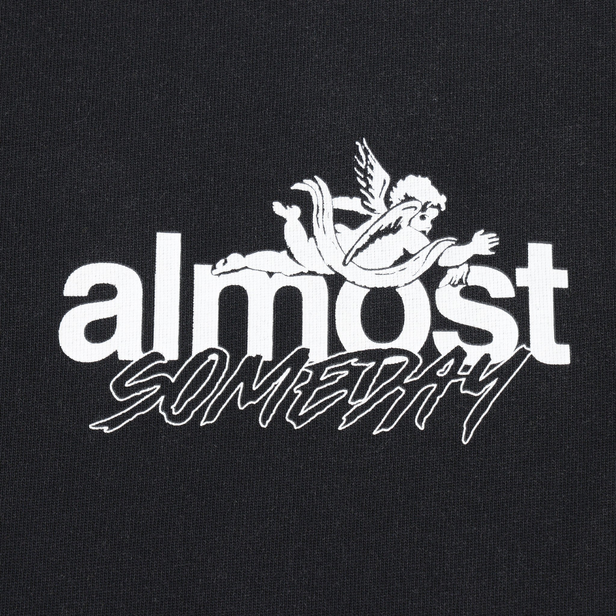 Enemies Tee – Black – Close-up of white ALMOST SOMEDAY chest lettering and winged figure logo