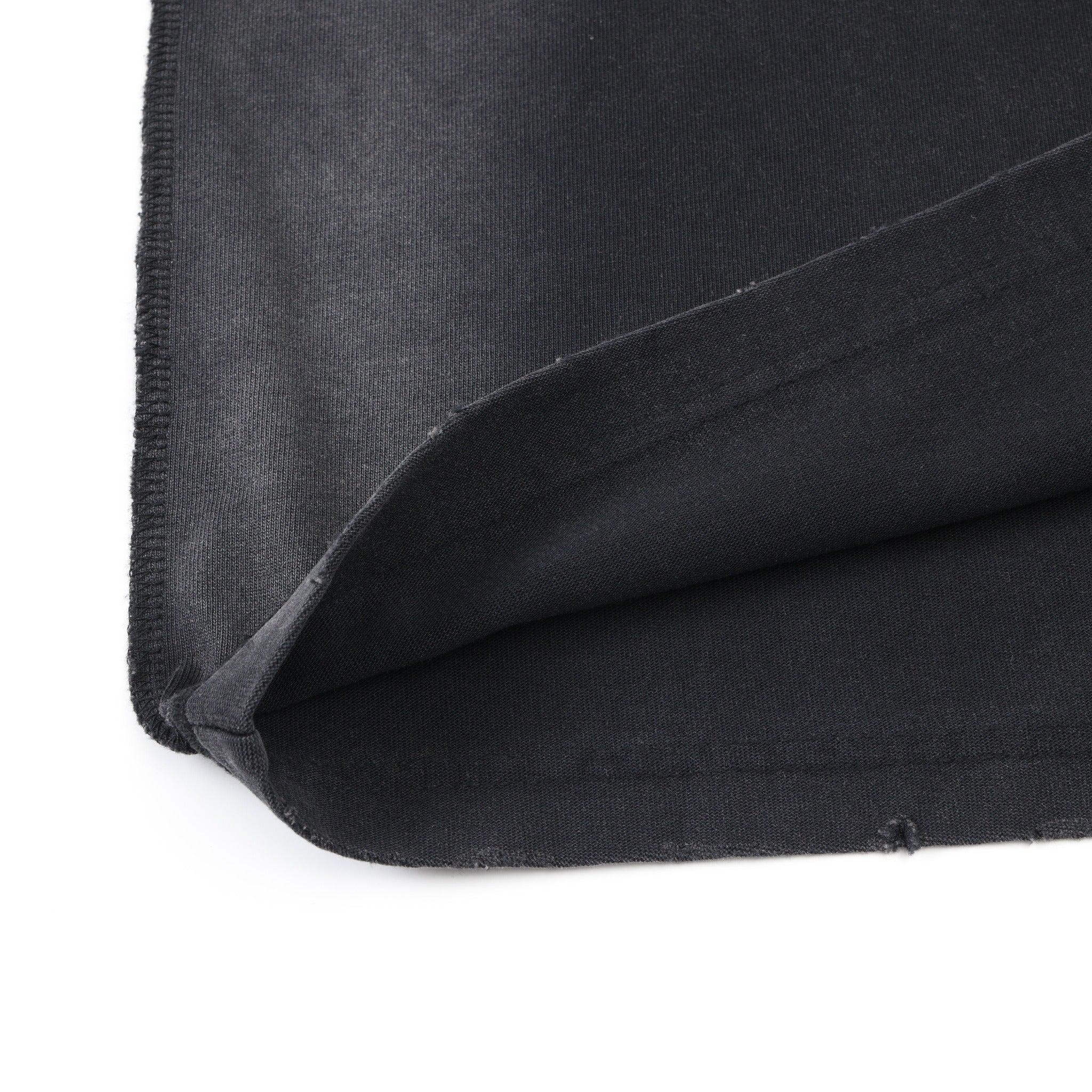 Enemies Tee – Black – Close-up of turned-up bottom hem and fabric underside