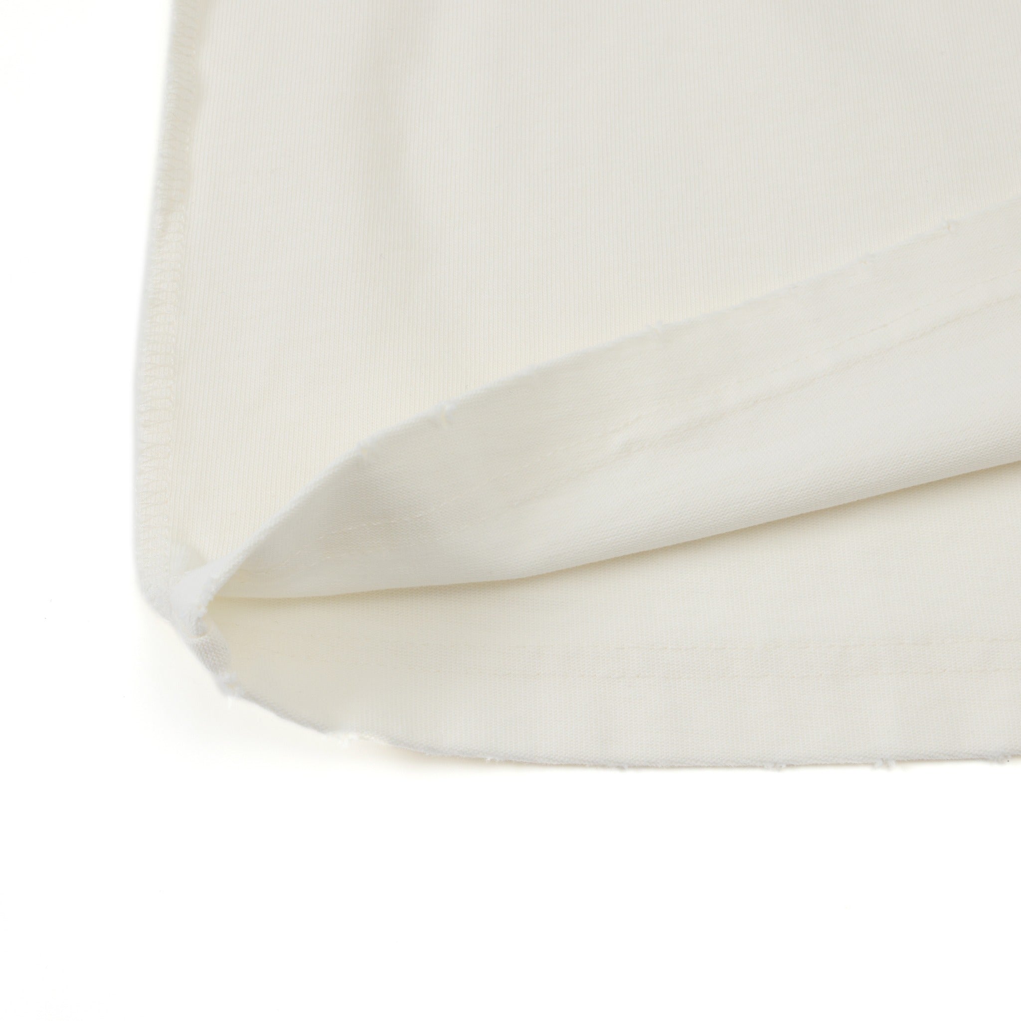 Enemies Tee – Cream – Close-up of turned-up bottom hem and fabric underside