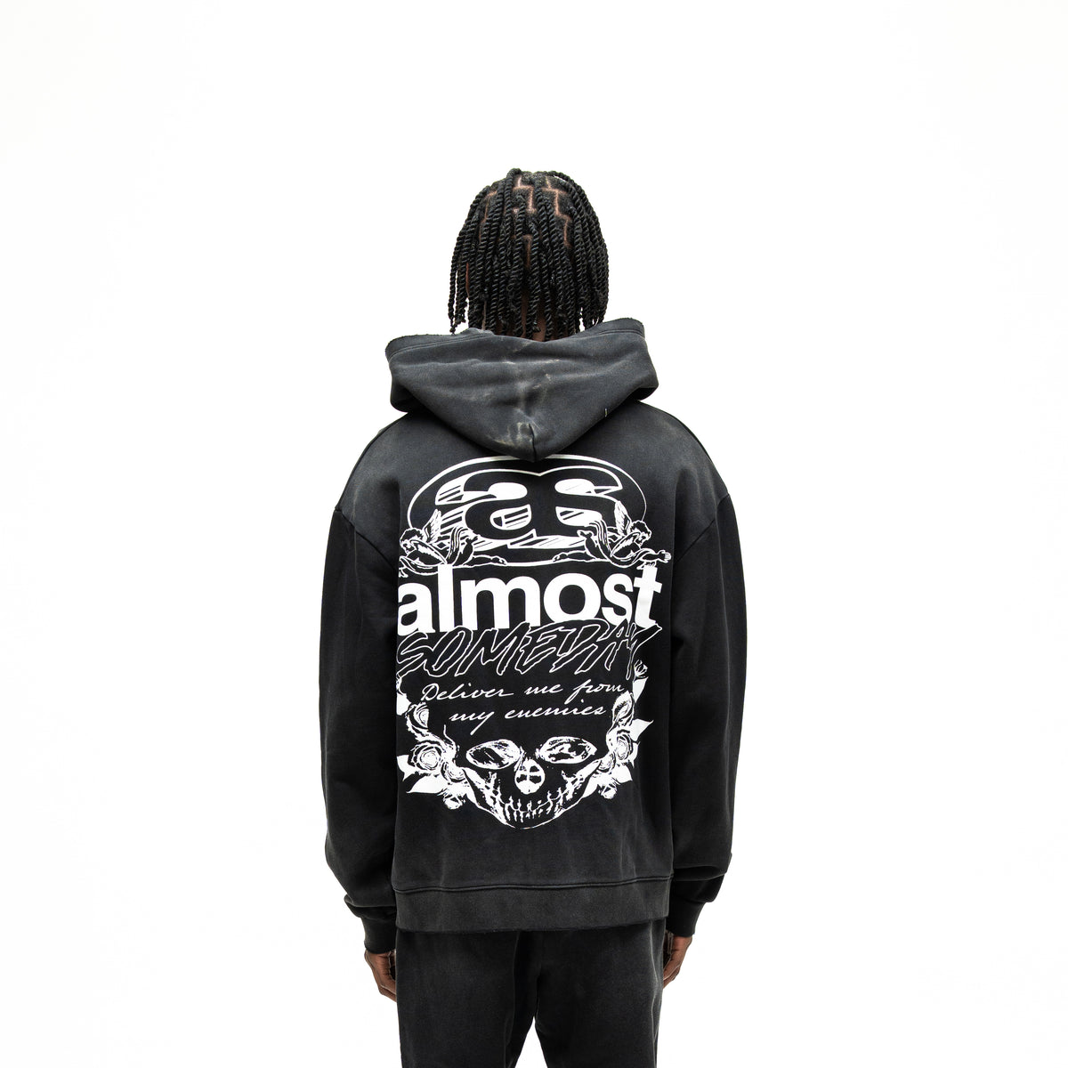Enemies Zip Hoodie – Black – Back view on model showing large white lettering, cherubs, roses, and skull artwork