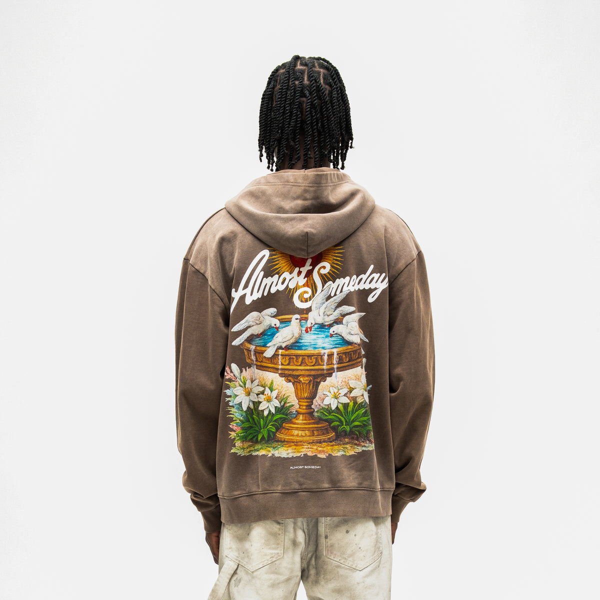 Fountain Hoodie – Brown – Back view on model showing large fountain graphic with white doves, flowers, and script branding