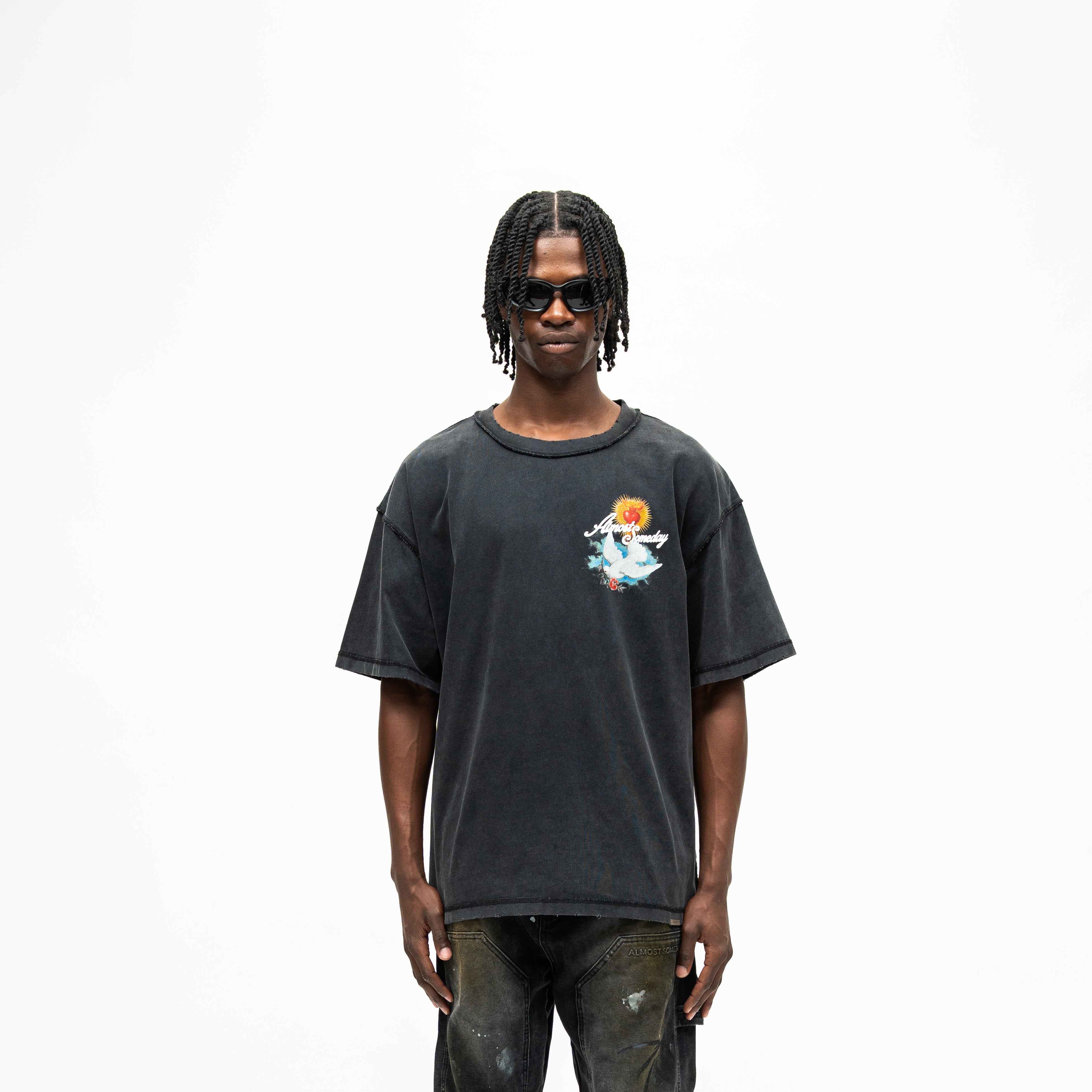 Fountain Tee – Black – Front view on model showing colorful chest graphic, short sleeves, and boxy fit