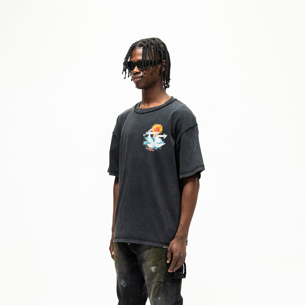 Fountain Tee – Black – Three-quarter front view on model showing chest graphic and dropped shoulders