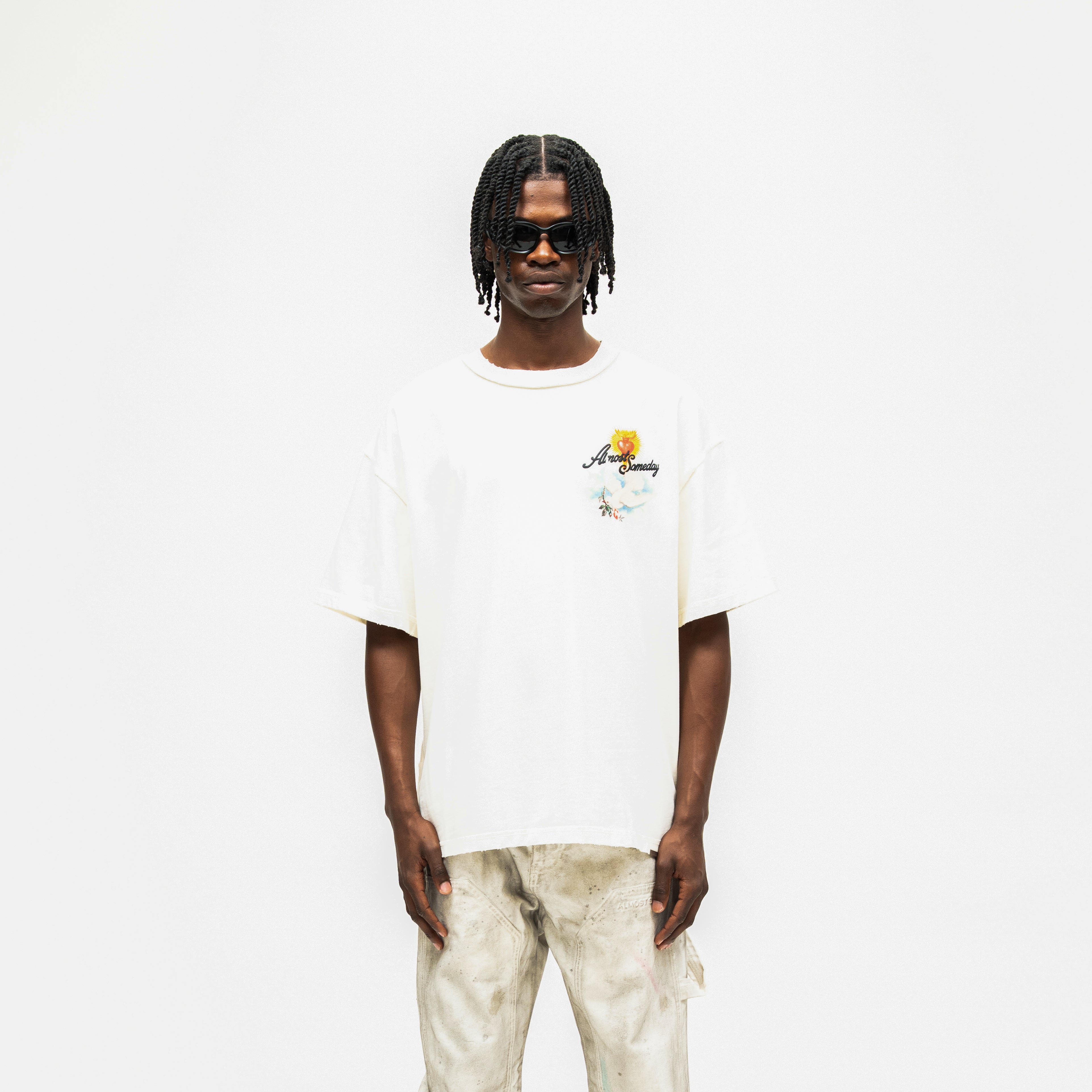 Fountain Tee – Cream – Front view on model showing chest graphic and relaxed fit