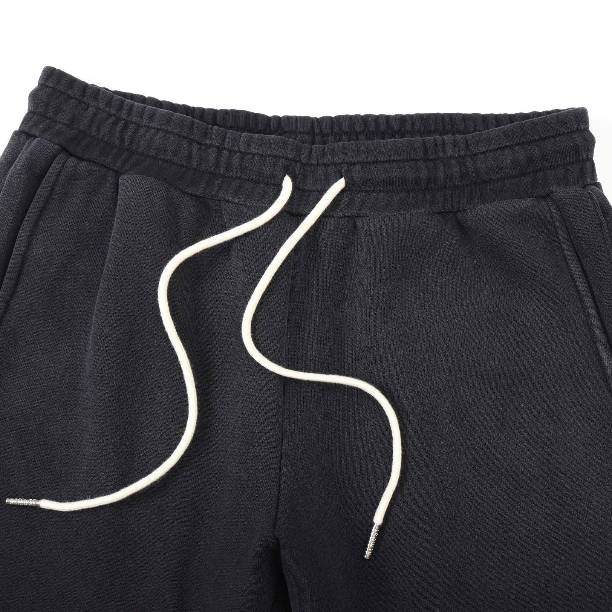 League Flare Sweatpants – Black – Close-up of elastic waistband, side pockets, and white drawstrings