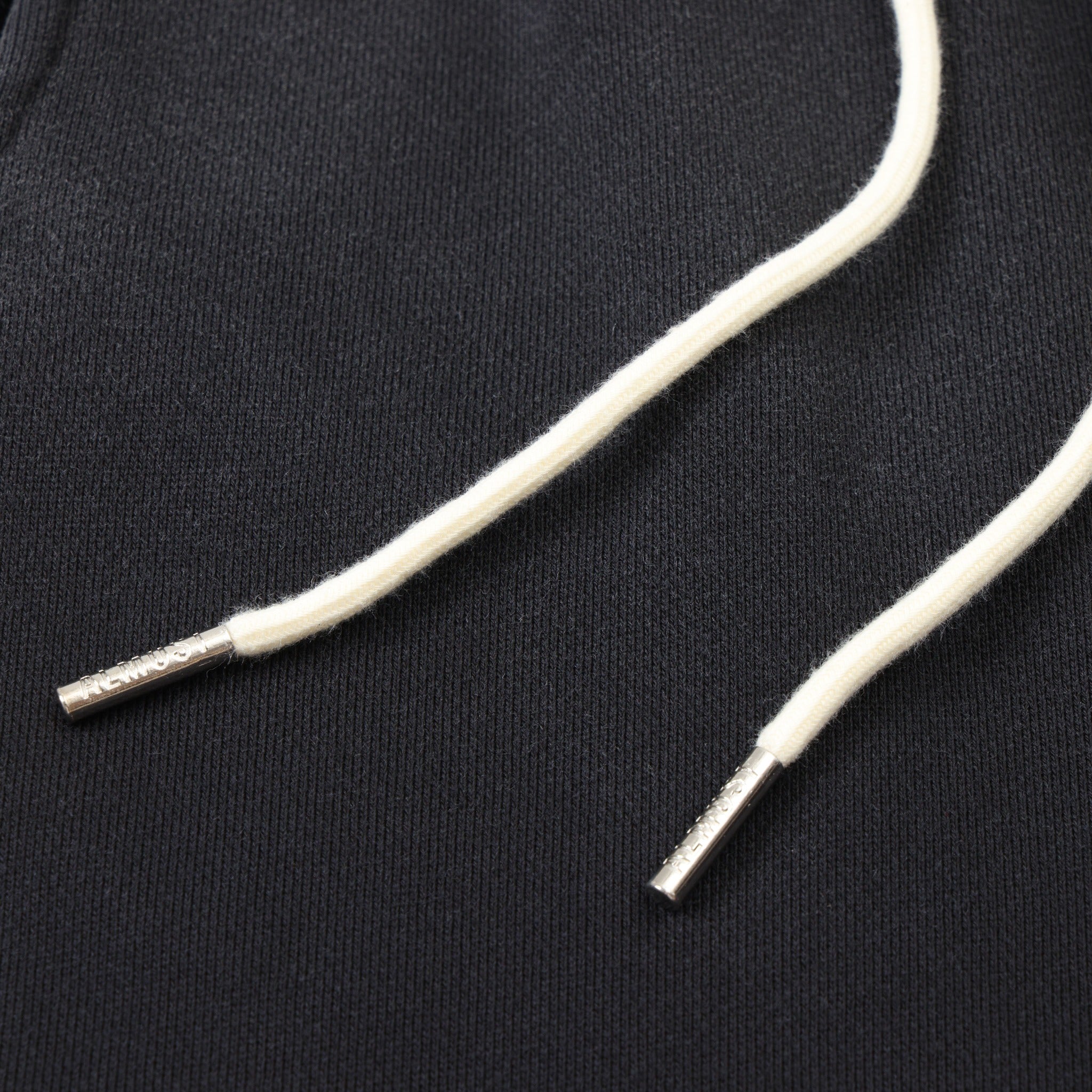 League Flare Sweatpants – Black – Close-up of white drawstrings with silver-tone metal tips