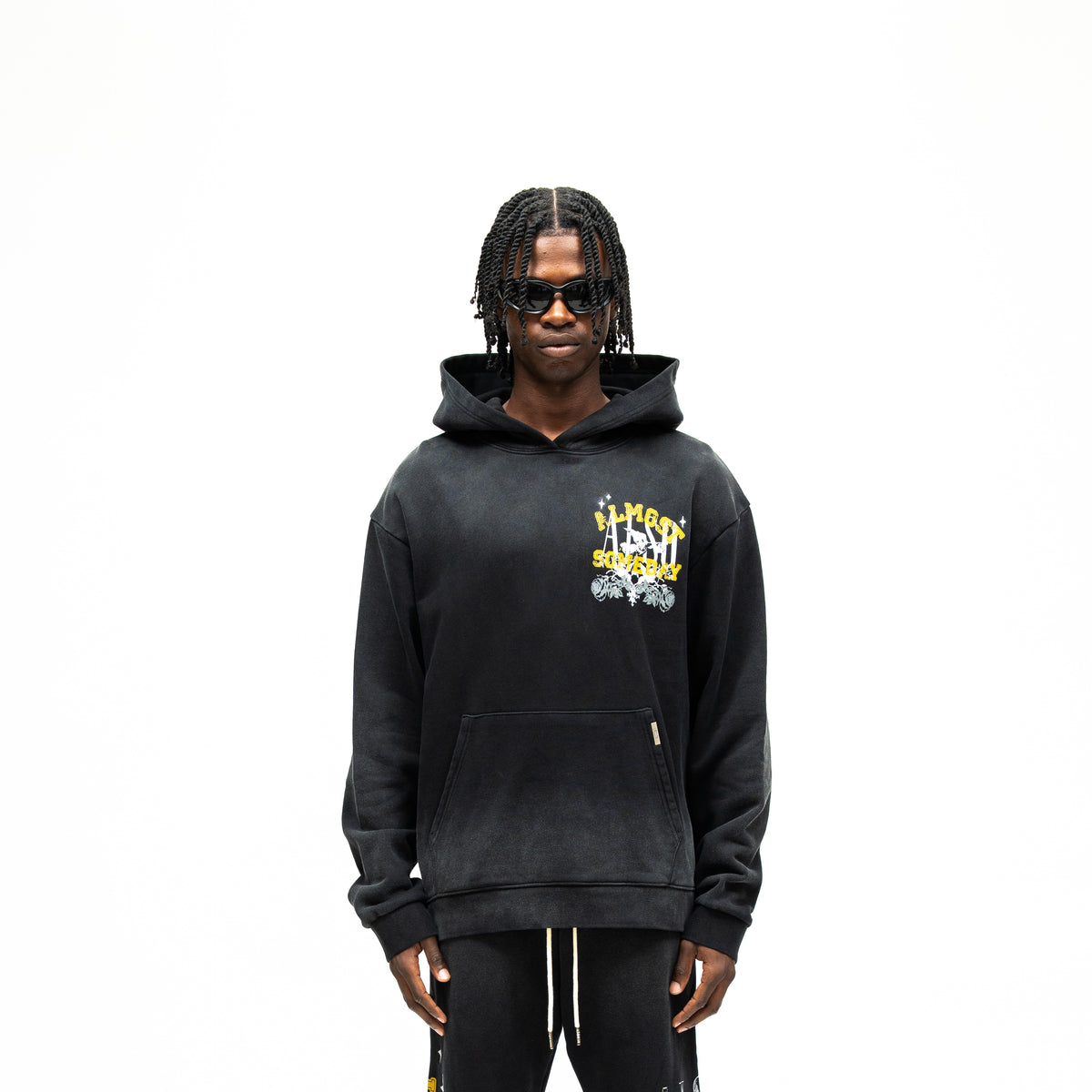 League Hoodie – Black – Front view on model showing chest graphic, hood, and kangaroo pocket