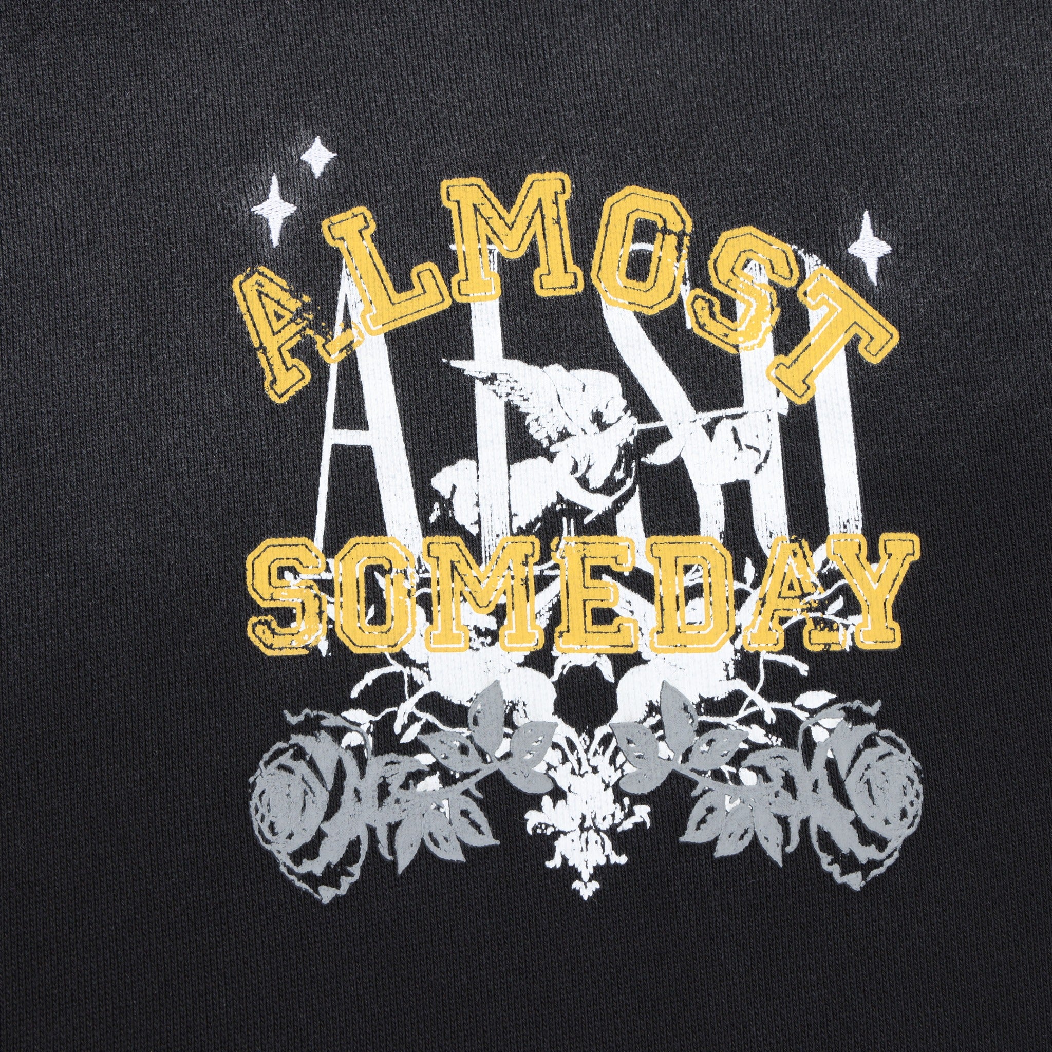 League Hoodie – Black – Close-up of yellow lettering, white cherub, and grey roses on chest