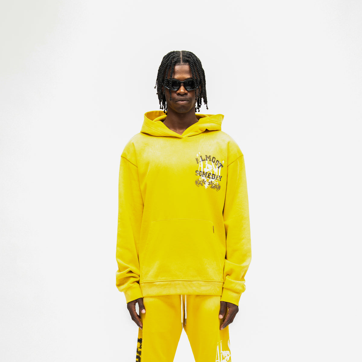 League Hoodie – Yellow – Front view on model showing chest graphic, hood, and kangaroo pocket