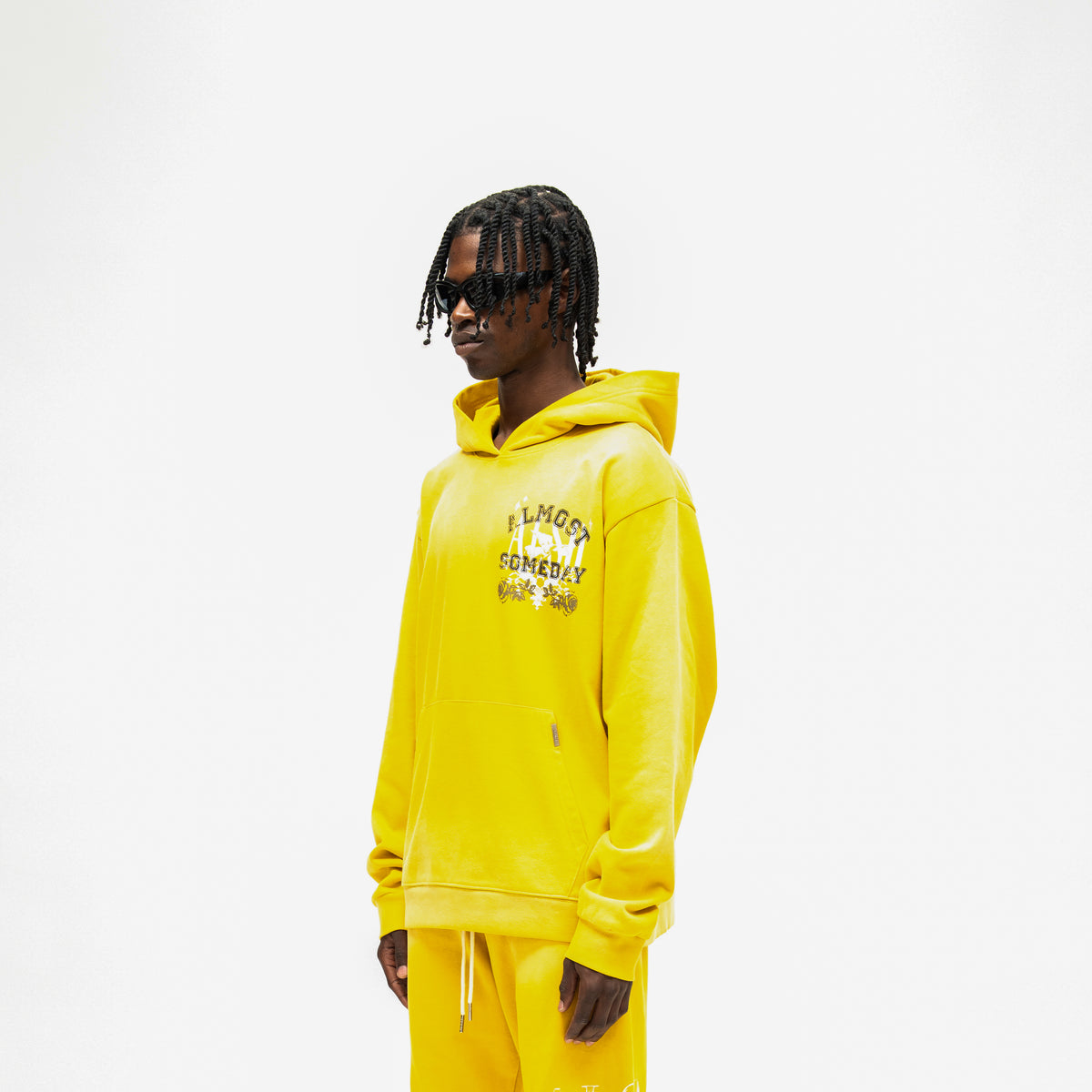 League Hoodie – Yellow – Three-quarter front view on model showing chest graphic and dropped shoulders