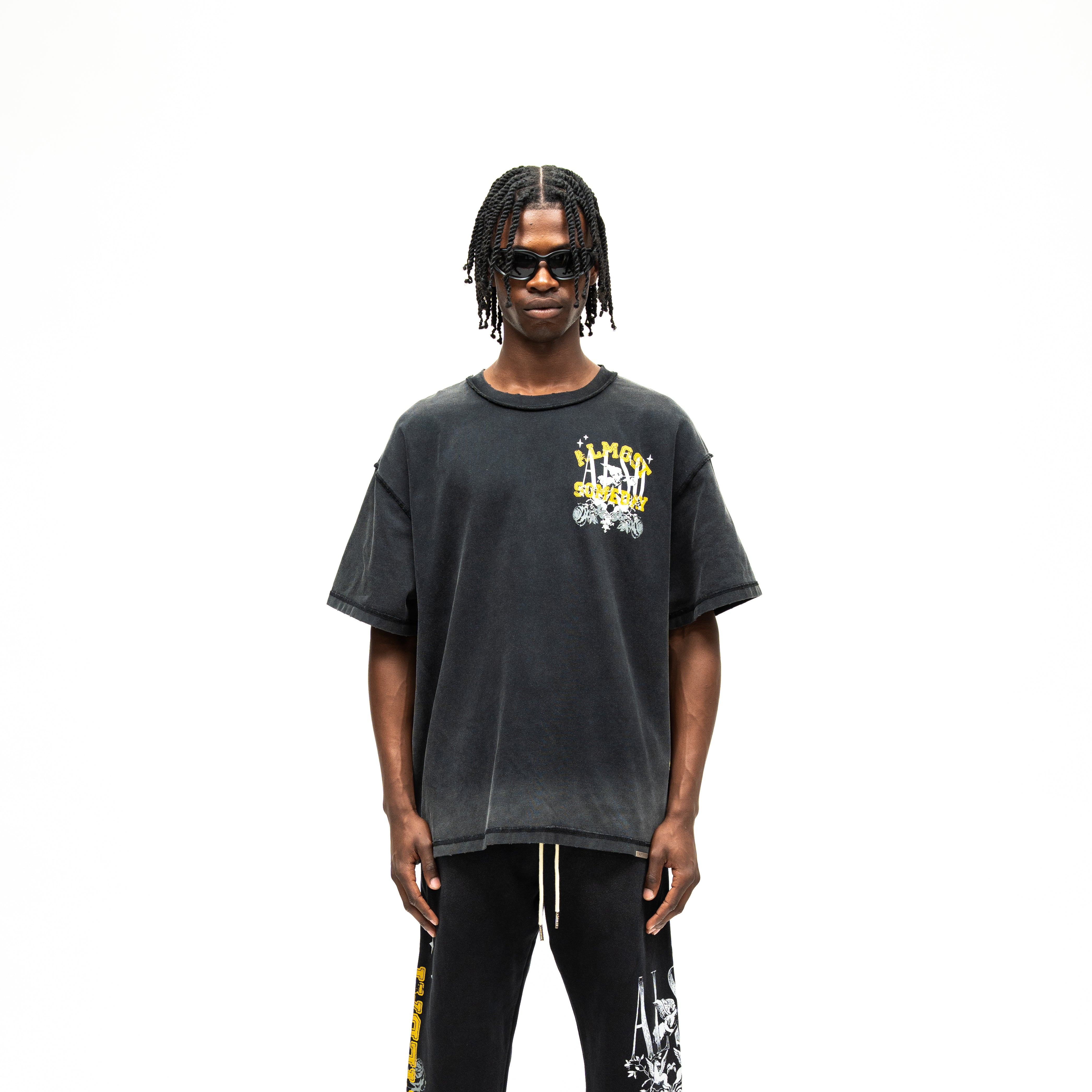 League Tee – Black – Front view on model showing chest graphic and boxy fit