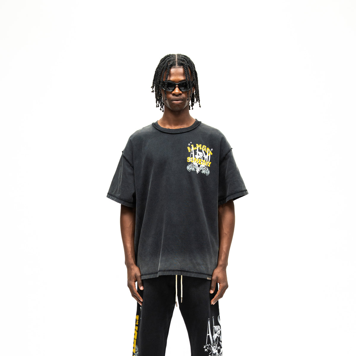 League Tee – Black – Front view on model showing chest graphic and boxy fit