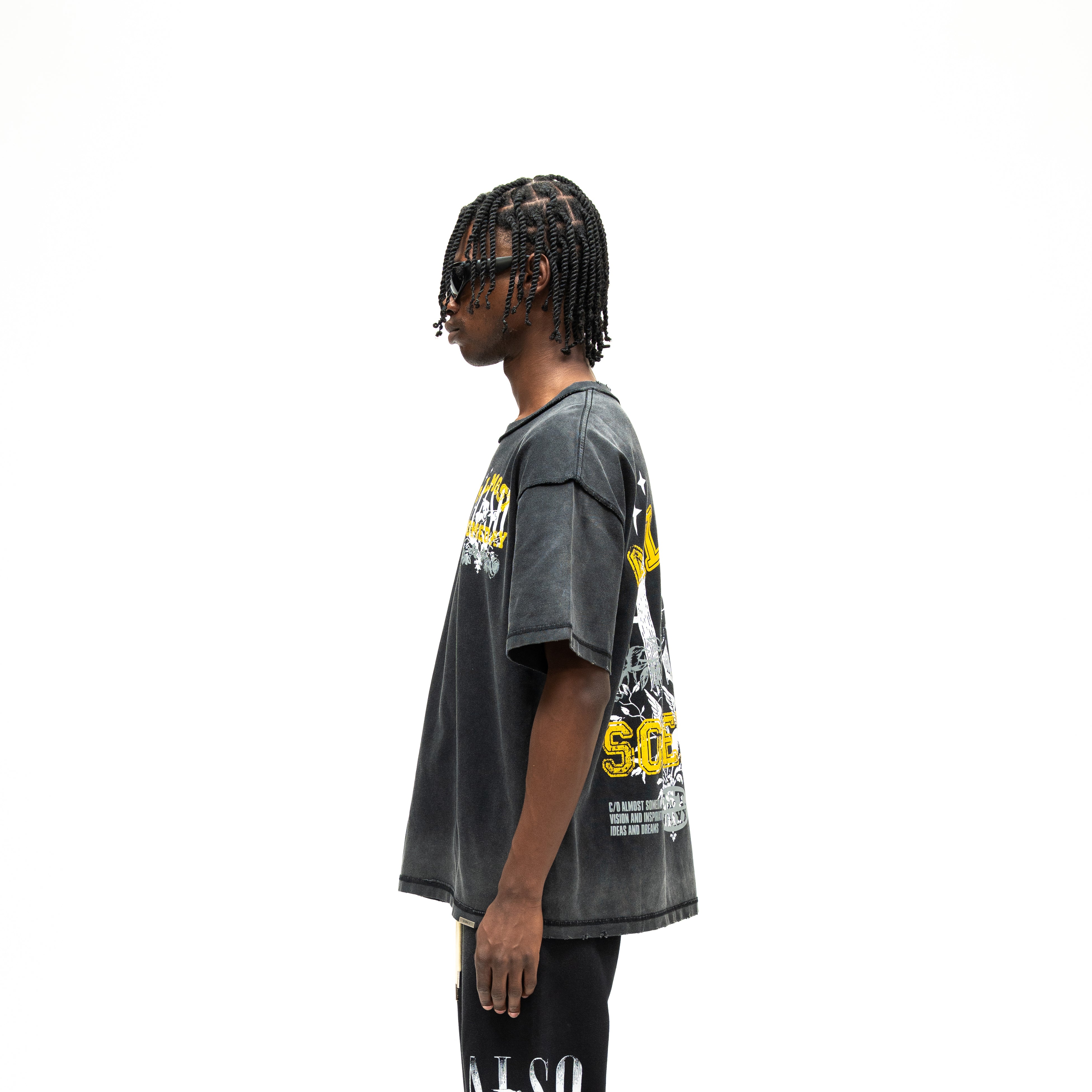 League Tee – Black – Side view on model showing relaxed silhouette and short sleeves, and partial back graphic design