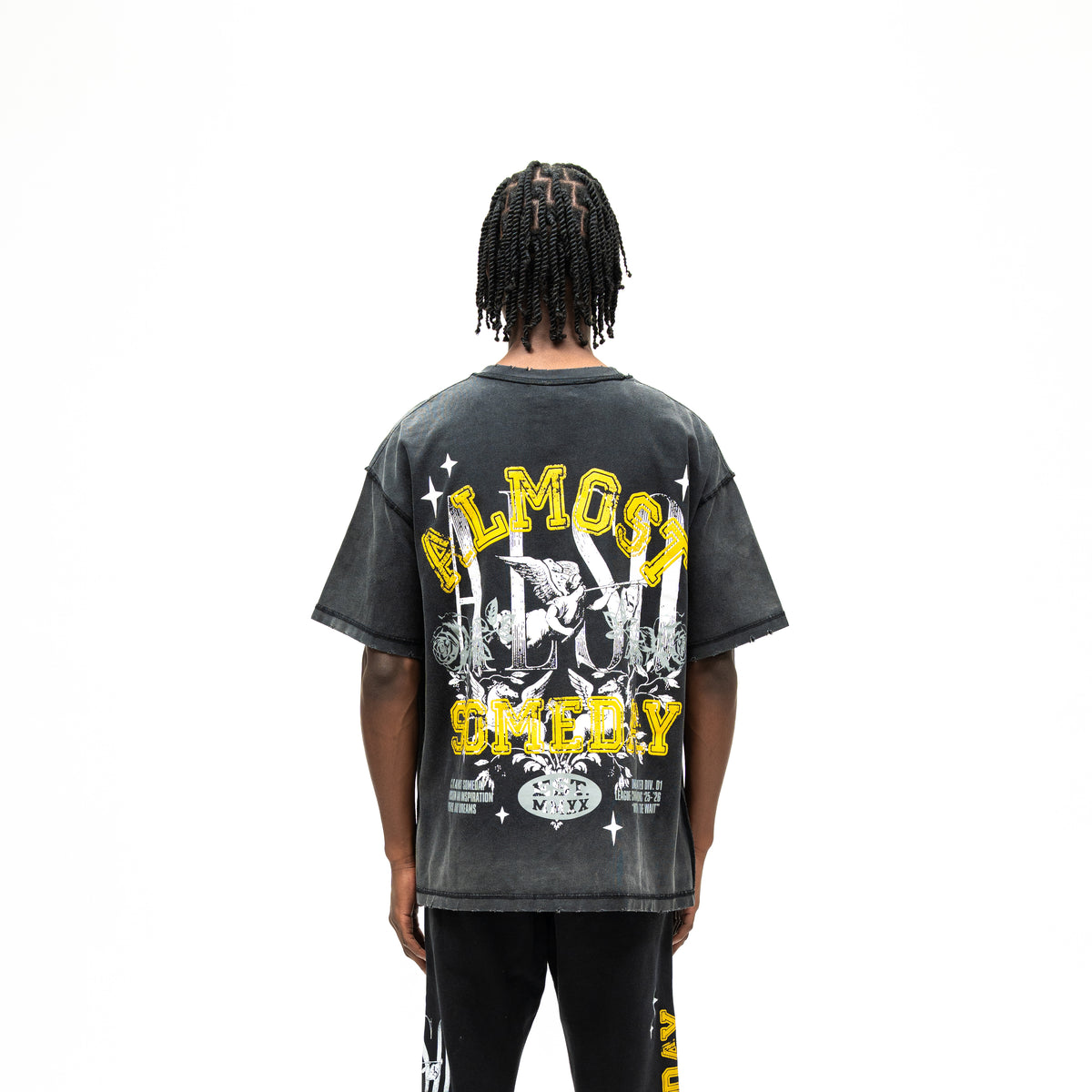 League Tee – Black – Back view on model showing oversized lettering, cherub, and rose graphic
