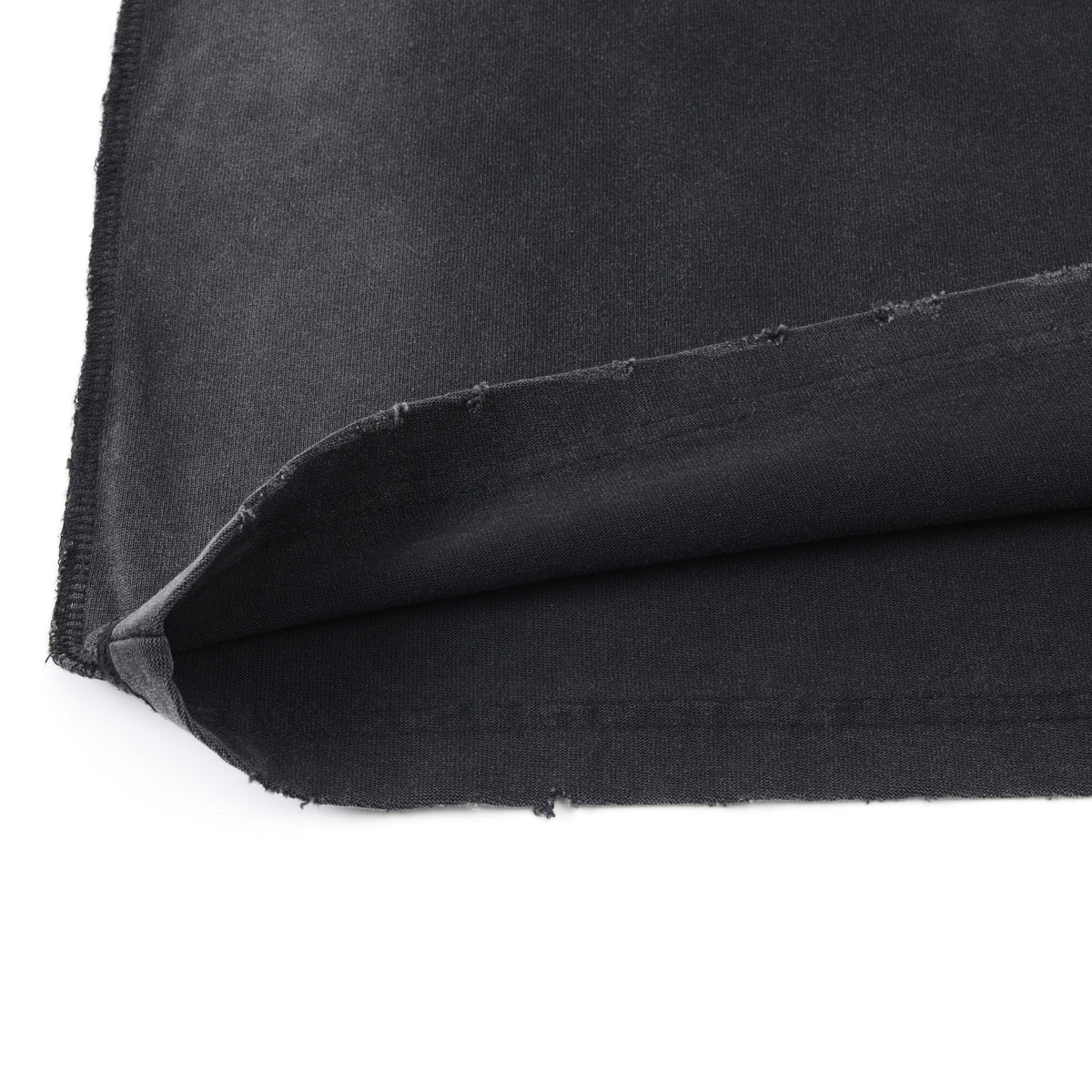 League Tee – Black – Close-up of turned-up distressed hem and fabric underside