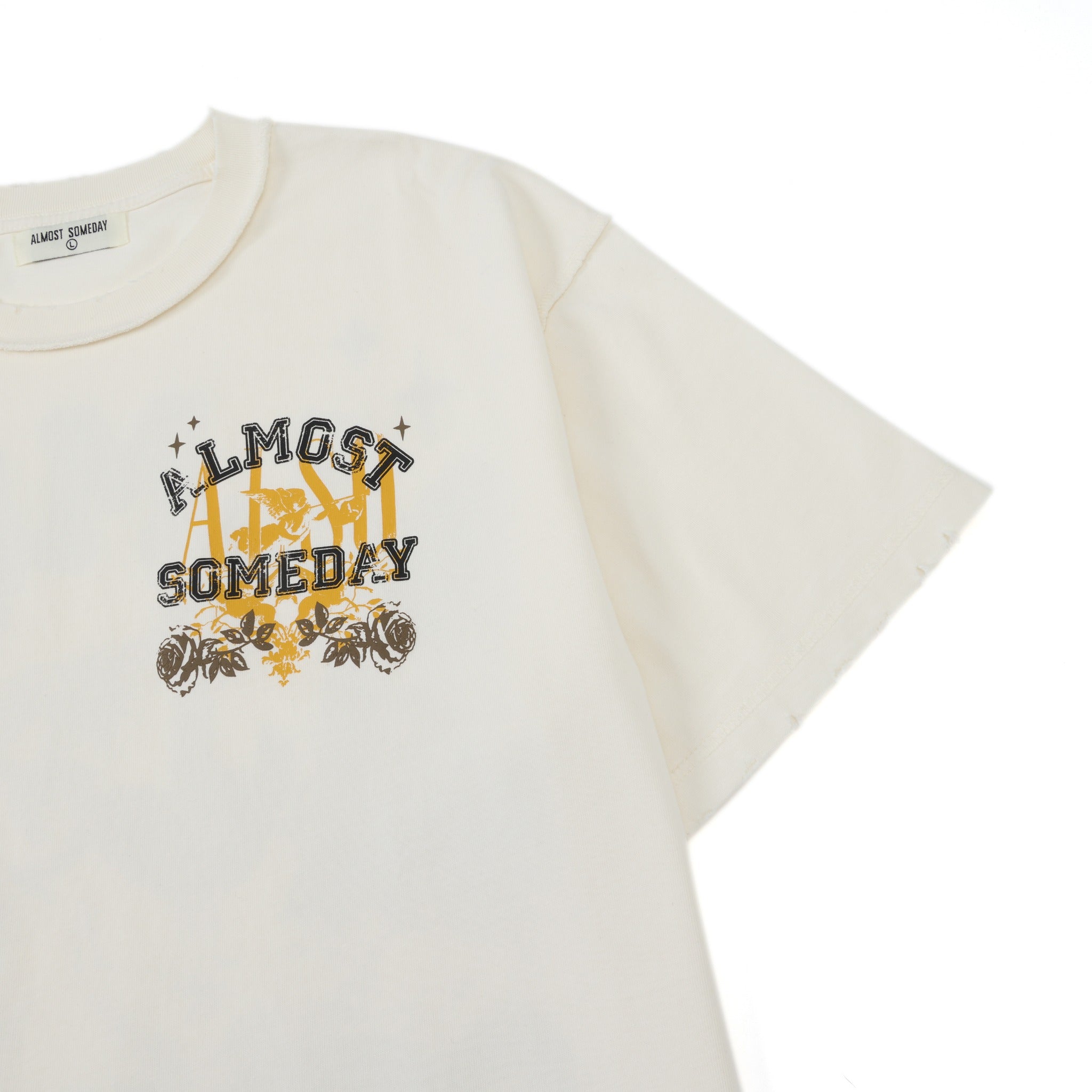League Tee – Cream – Angled close-up showing chest graphic and sleeve