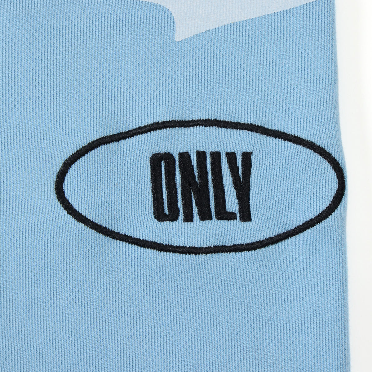 Members Flare Sweatpants – Light Blue – Close-up of black Only embroidery inside an oval