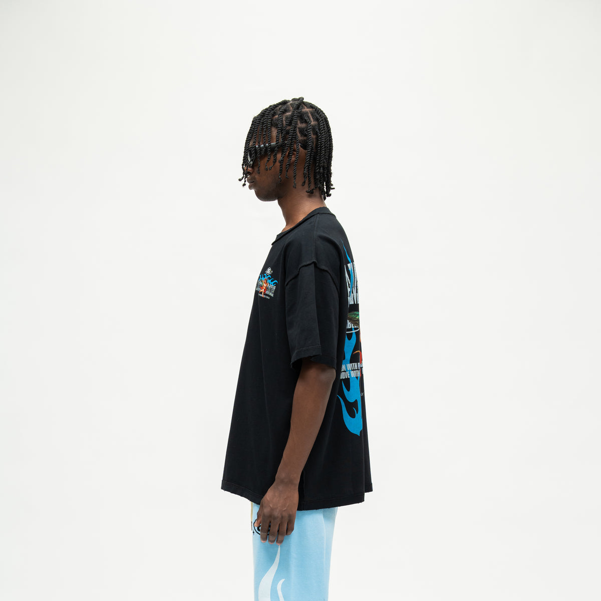 Members Tee – Black – Side view on model showing short sleeve, straight hem, and partial blue back artwork
