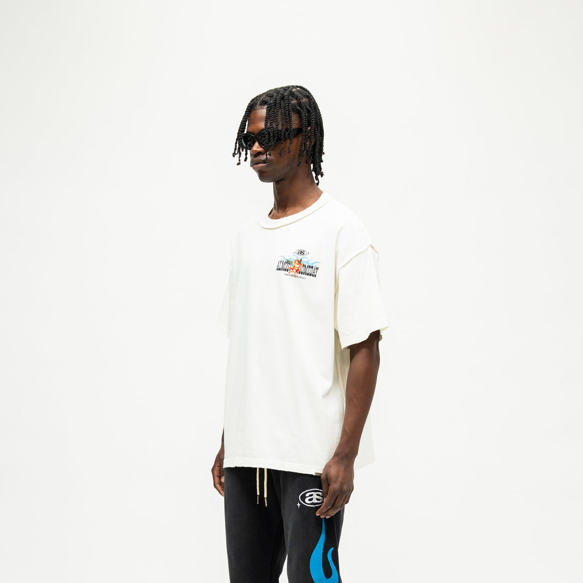 Members Tee – Cream – Three-quarter front view on model showing small chest artwork and dropped shoulders