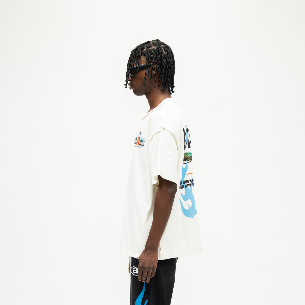 Members Tee – Cream – Side view on model showing short sleeve, straight hem, and partial blue back artwork