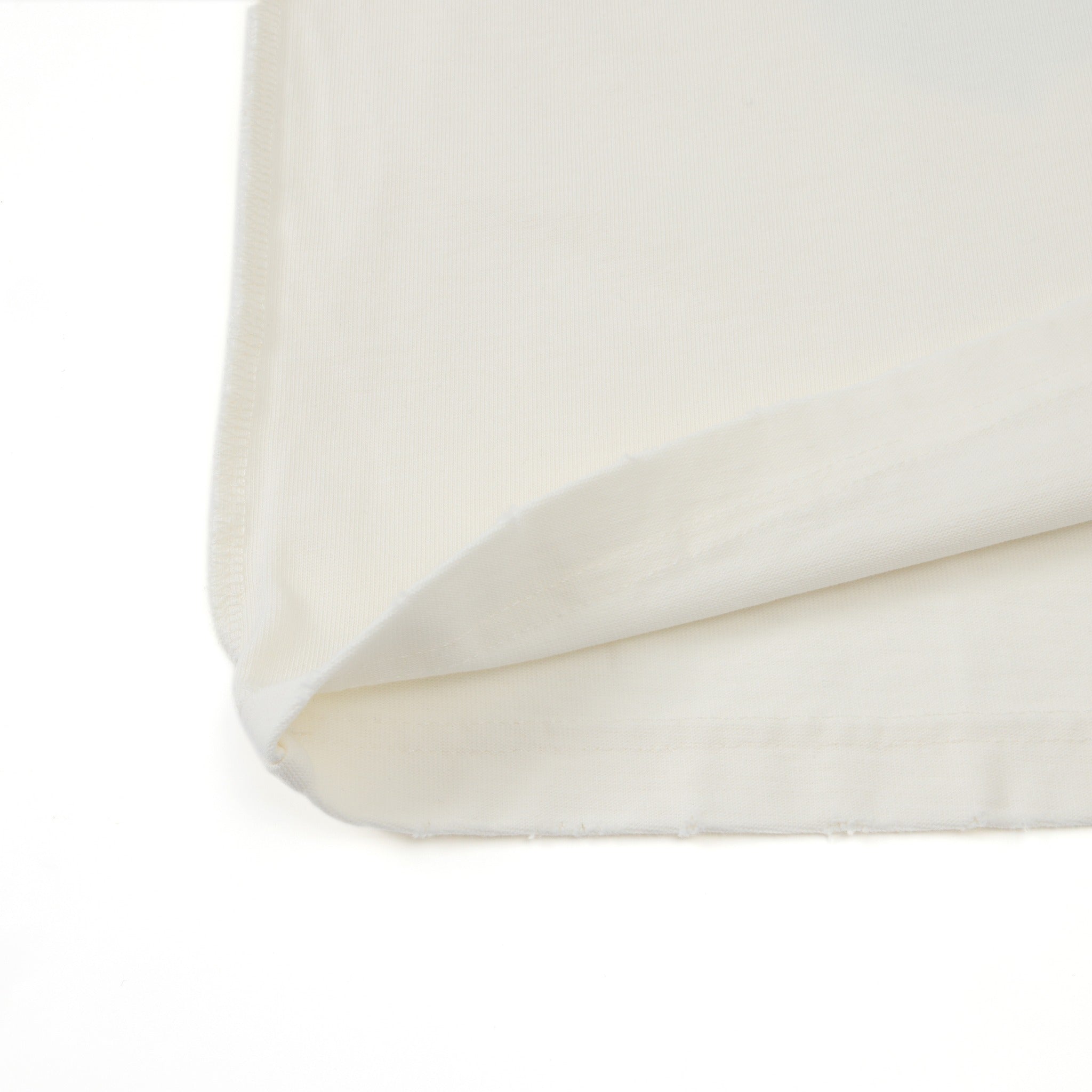 Members Tee – Cream – Close-up of folded bottom hem and fabric edge