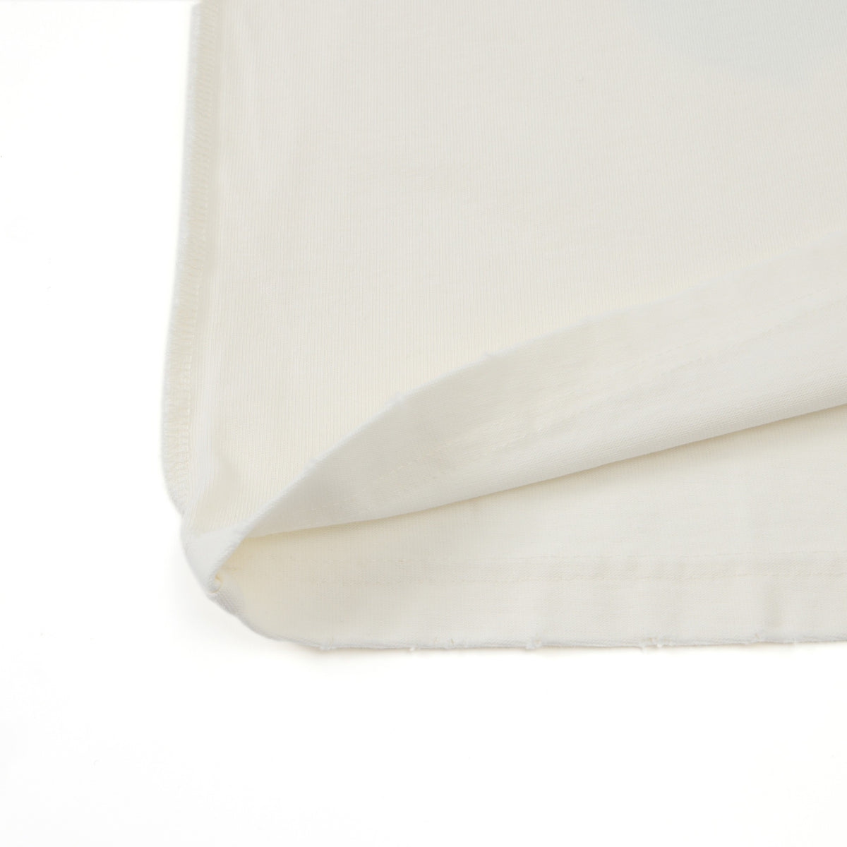 Members Tee – Cream – Close-up of folded bottom hem and fabric edge